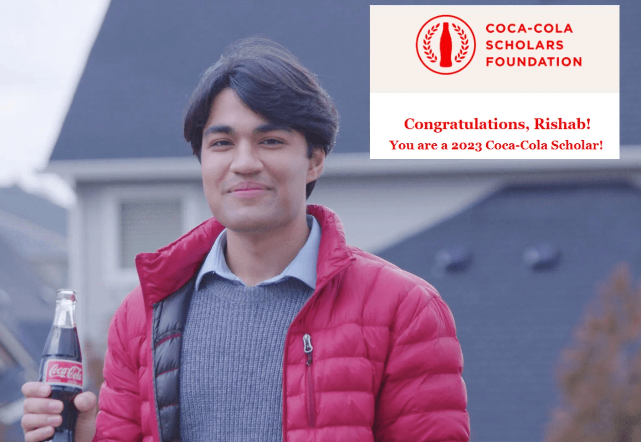 Rishab Jain holds a coke bottle as a 2023 Coca Cola Scholar
