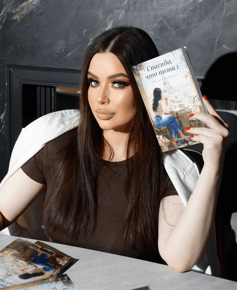 A couple embraces lovingly on a wooden dock.