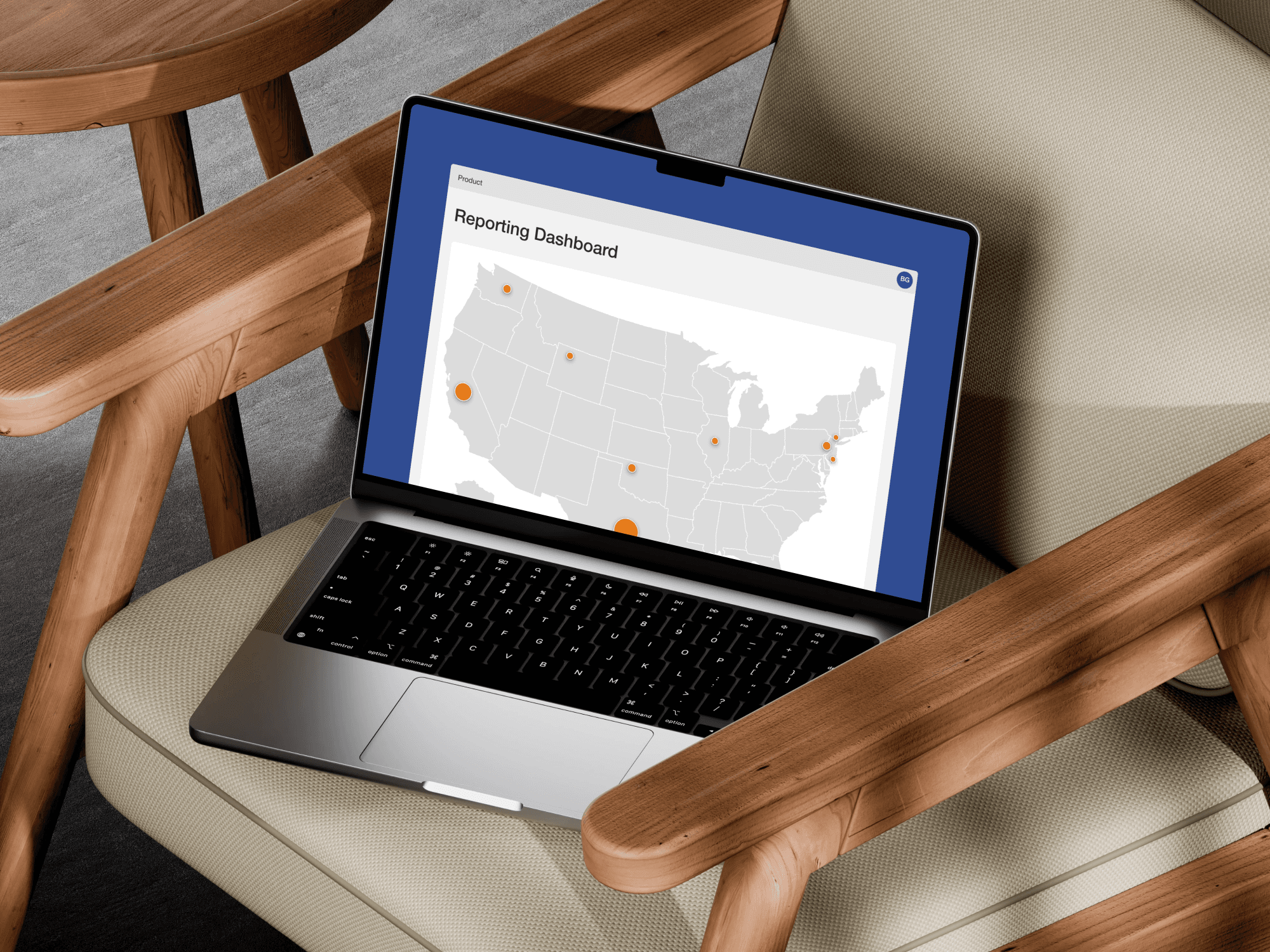 A laptop on a chair with screen showing a reporting dashboard page