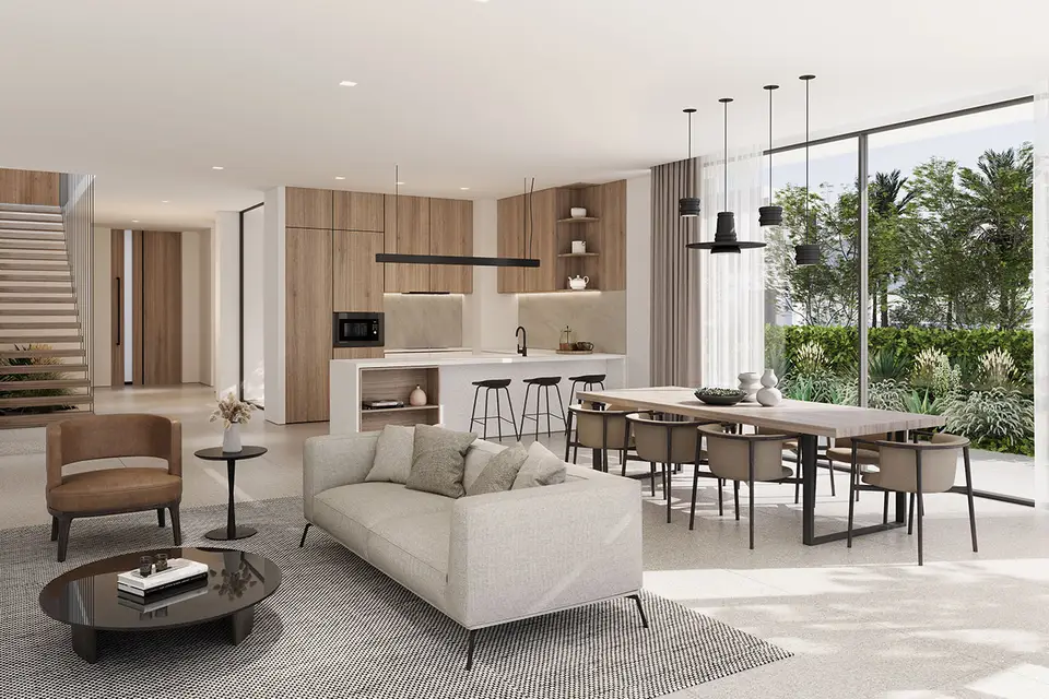 A bright living room in Yasmina Villa, showcasing large windows that overlook the vibrant cityscape outside.
