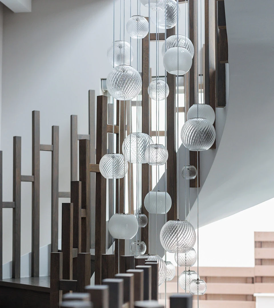 Seafront Residence Limassol sculptural stairwell lighting with cascading glass pendants and modern metal balustrade