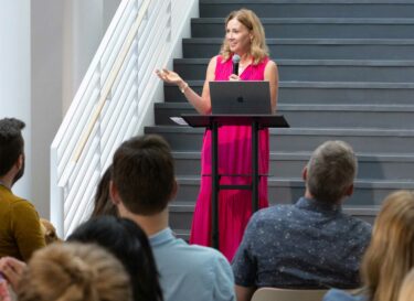 Ali Mahaffy speaking to gathered Signal Theory employees