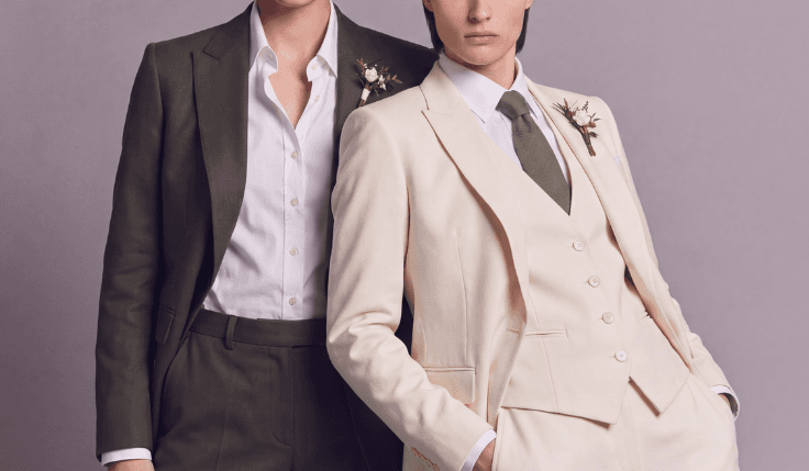 Two women in bespoke wedding suits styled with a tie and open collar