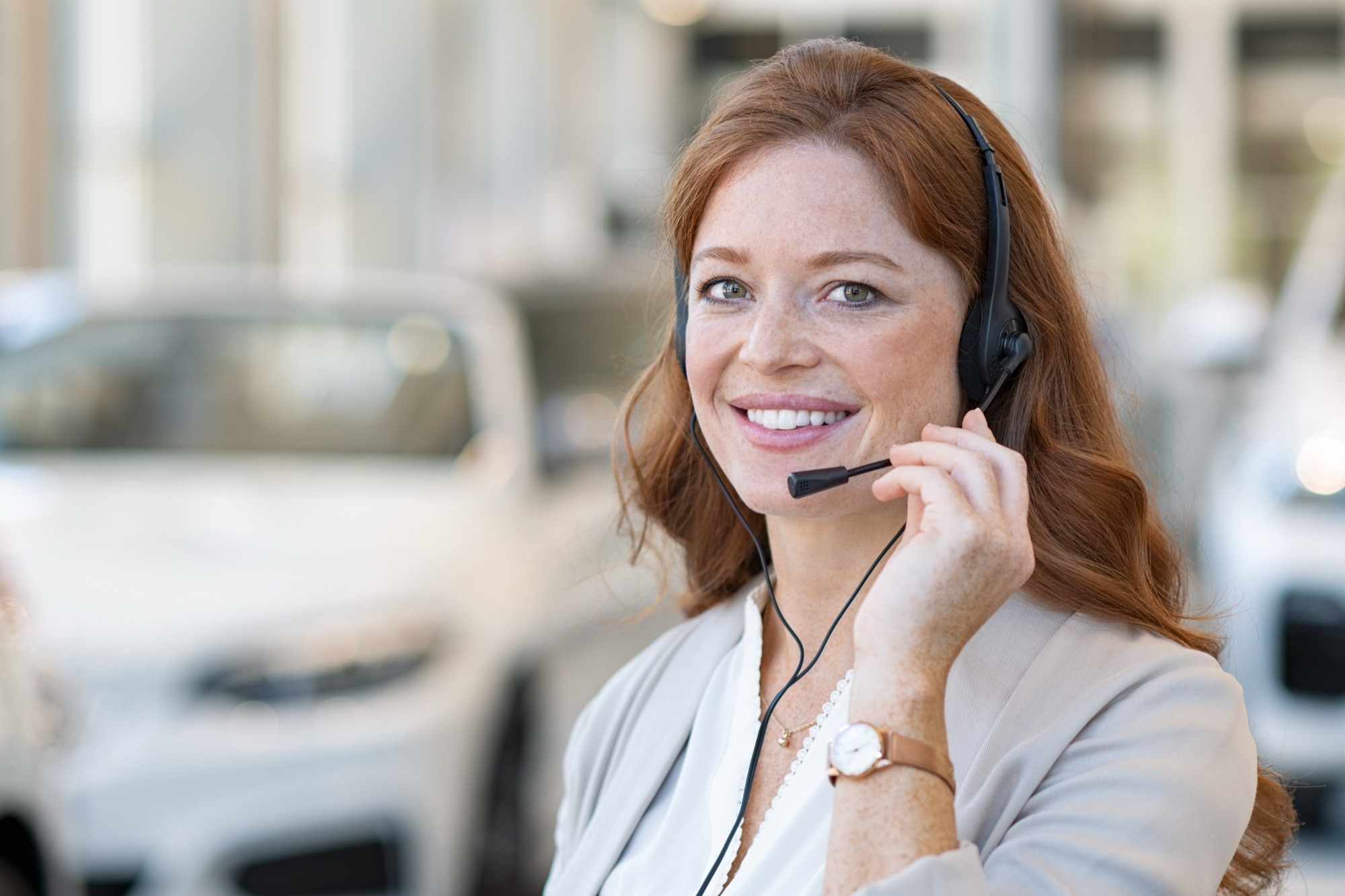 Beautiful customer support wearing headset and looking at camera.