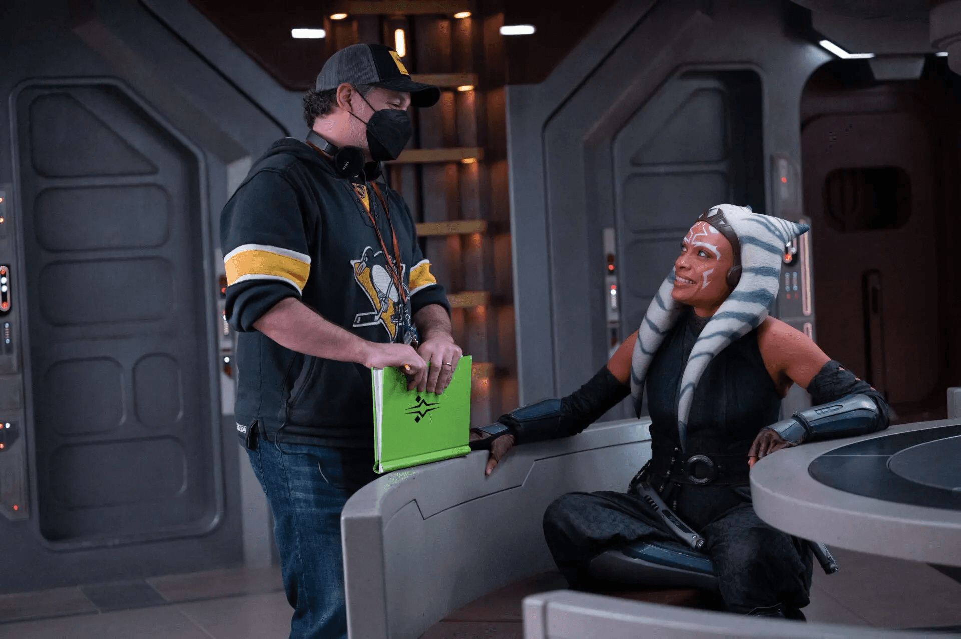 Dave Filoni and Rosario Dawson sharing a laugh in the ship set