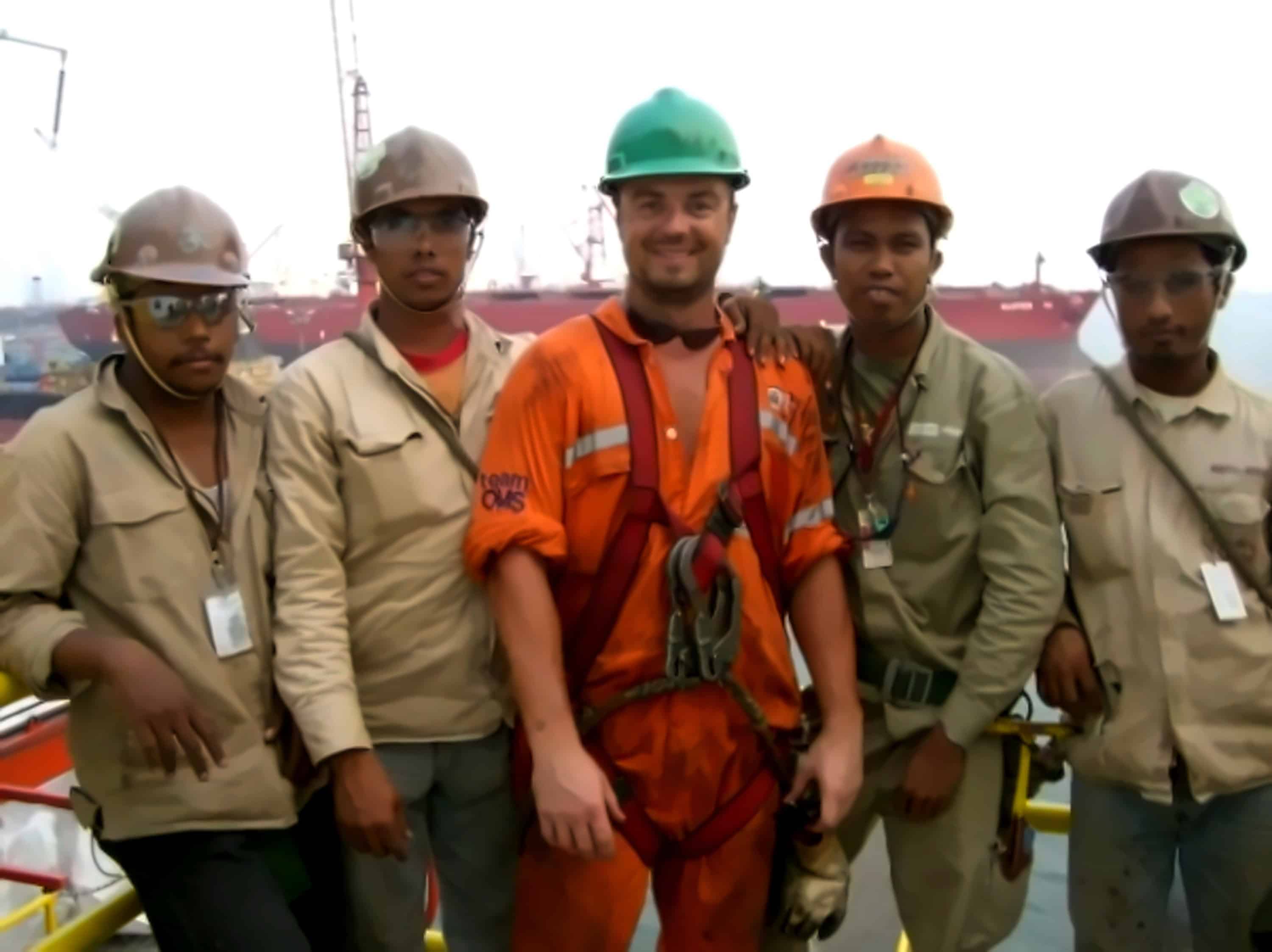 Ian Collins from Wellbeing Daily working in a shipyard in Singapore when he first joined the oil and gas industry surrounded by shipyard workers