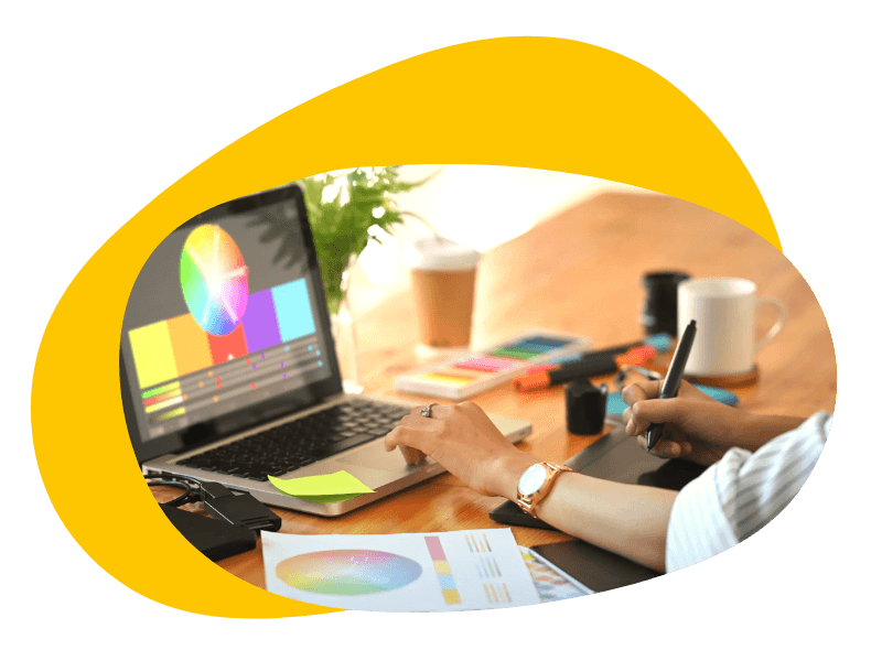 Graphic designer creating visual designs on a laptop