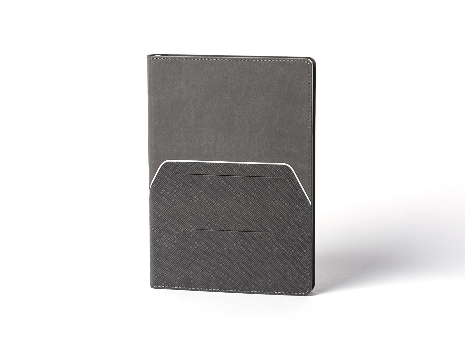 Front view of grey notebook with smooth top and geometric textured bottom.