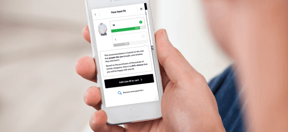 A man looking at the Fit Finder results screen on a smart phone