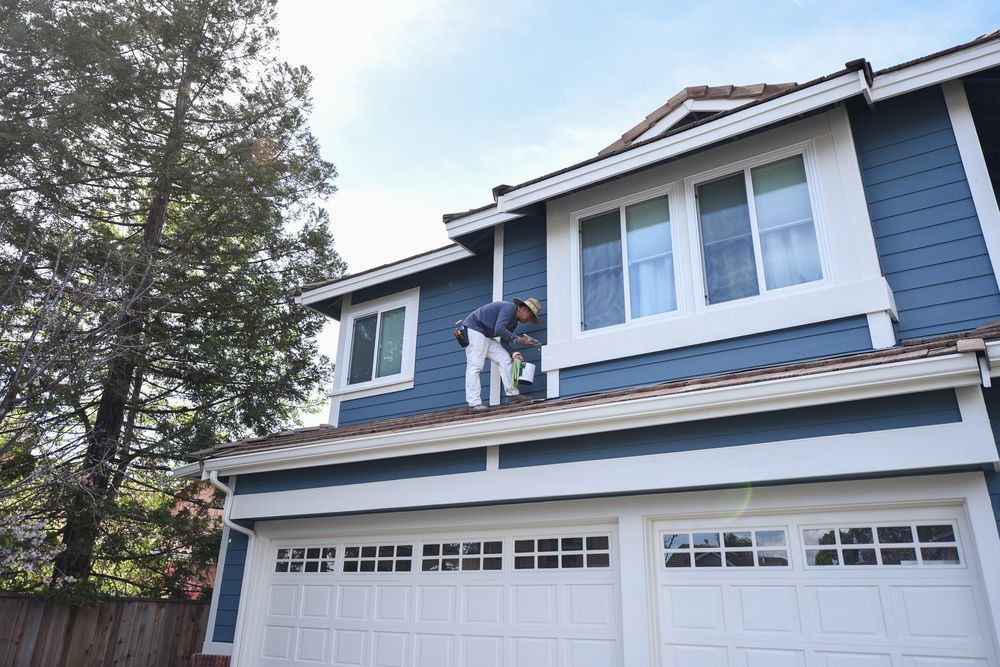 woman holding a phone and man looking at the phone. both are smiling