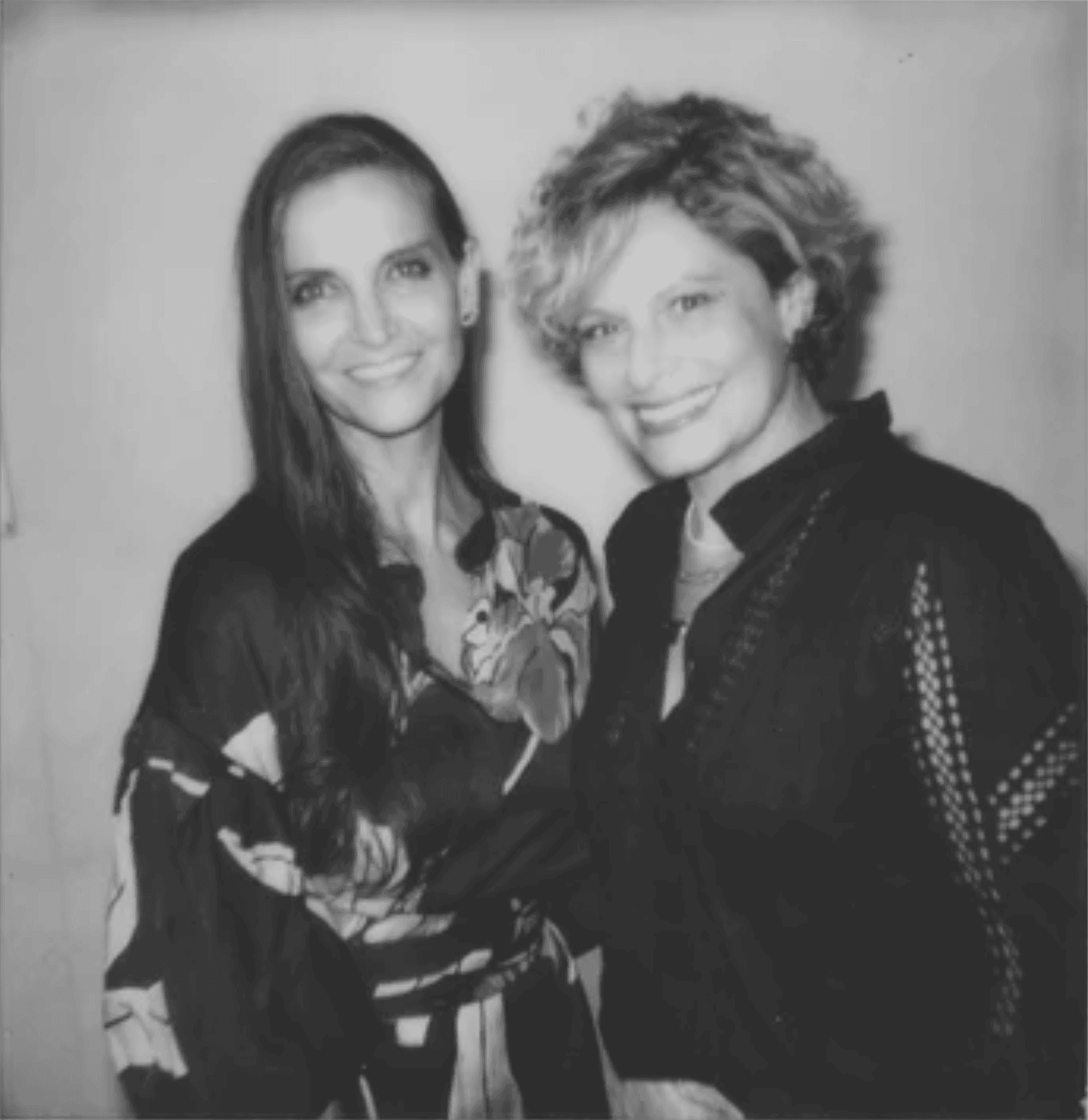 Two white woman smiling brightly.