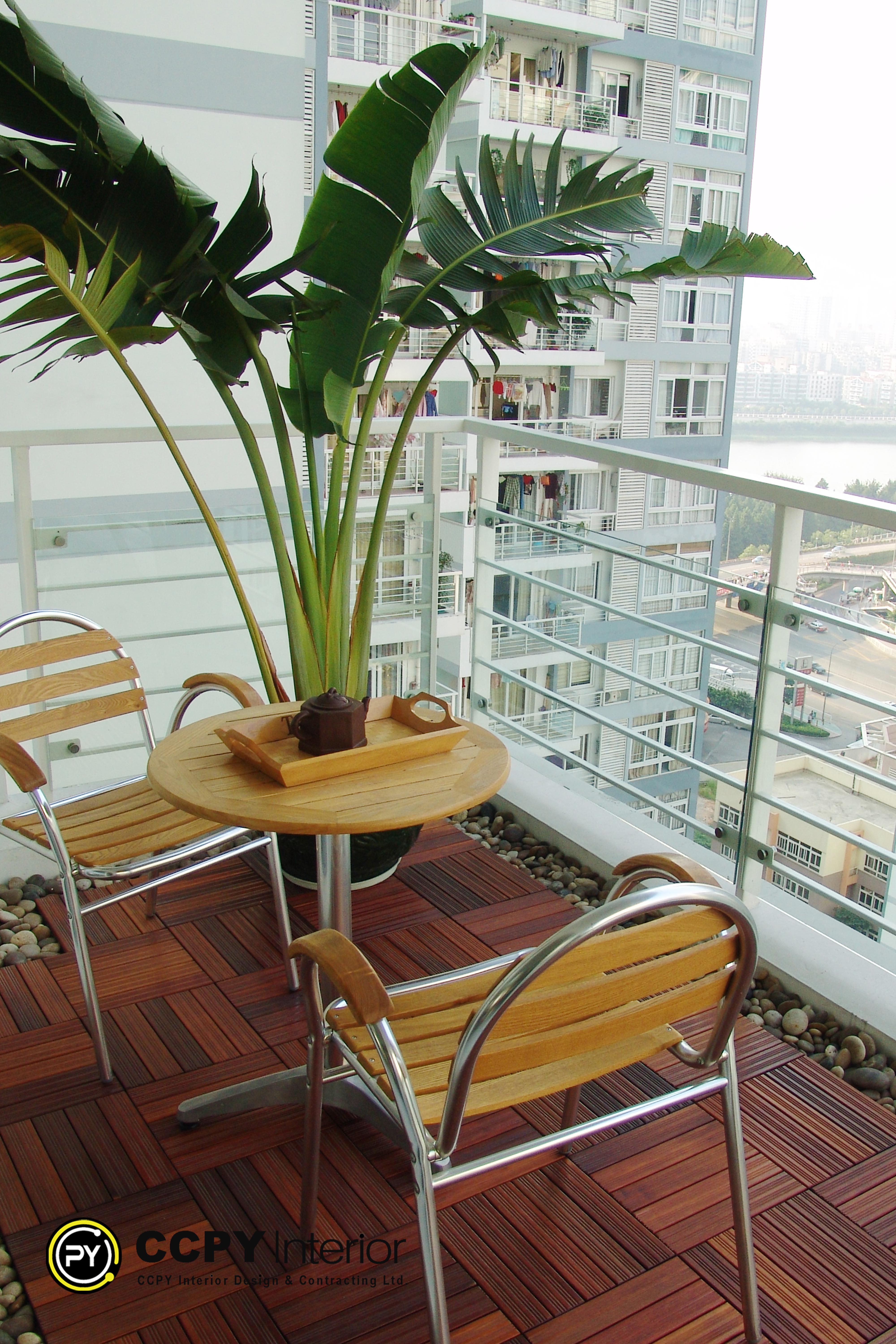 Expansive dining and living zone at Mount Pavilia 20 with floor-to-ceiling windows, a dark oval table, and seamless spatial flow between functional areas.