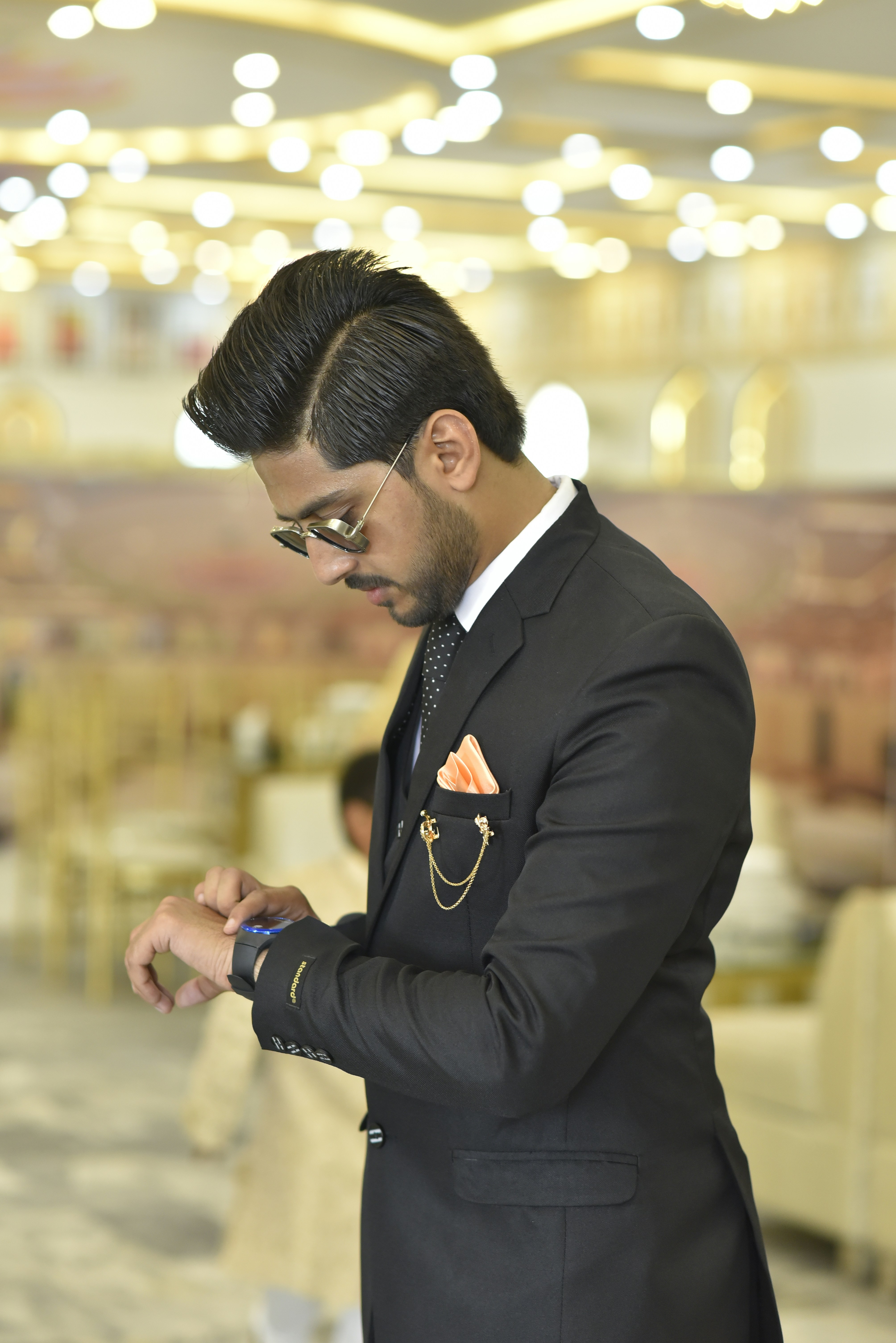 a man in a suit looking at his cell phone