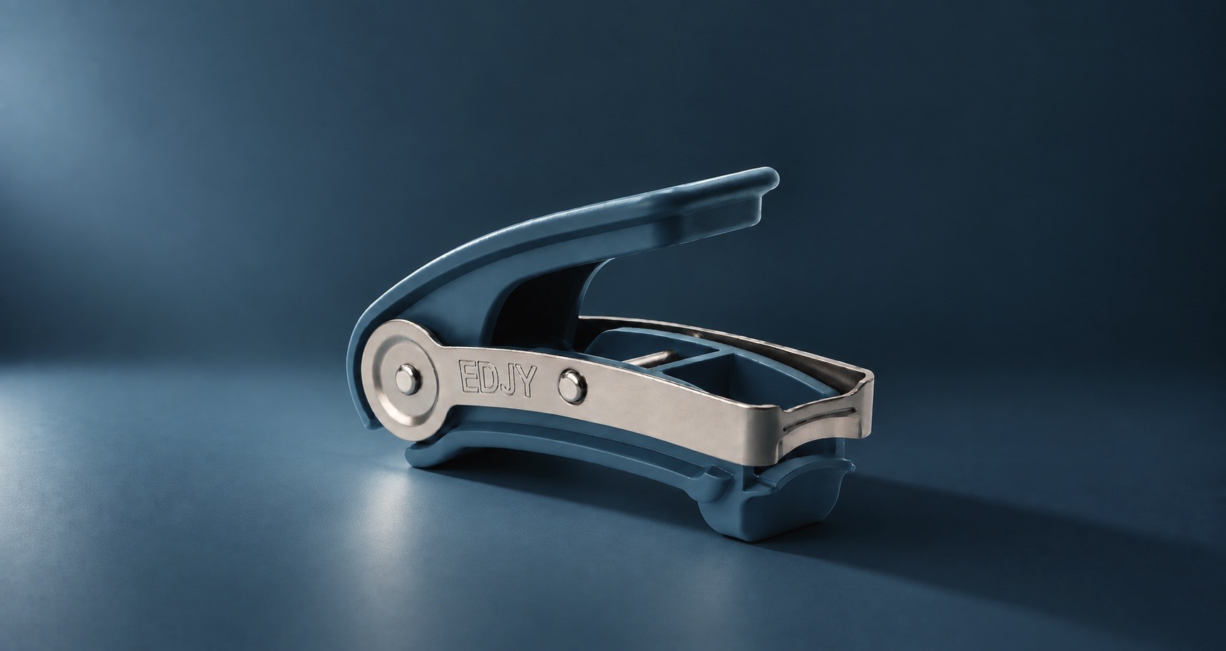 An open toenail cutter with a wide blue body and a stainless steel lever, photographed on a dark blue background.