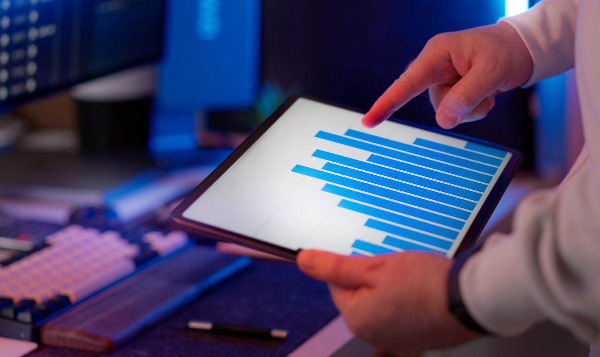 A marketing professional analysing recruitment engagement data on a tablet