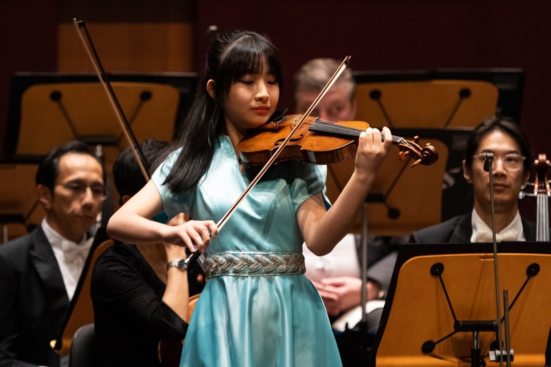Bright, spacious gallery interior with vaulted white arches, tall windows, and reflective wooden floors
