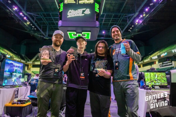 A group of tournament winners show off their GFG 2023 trophies.