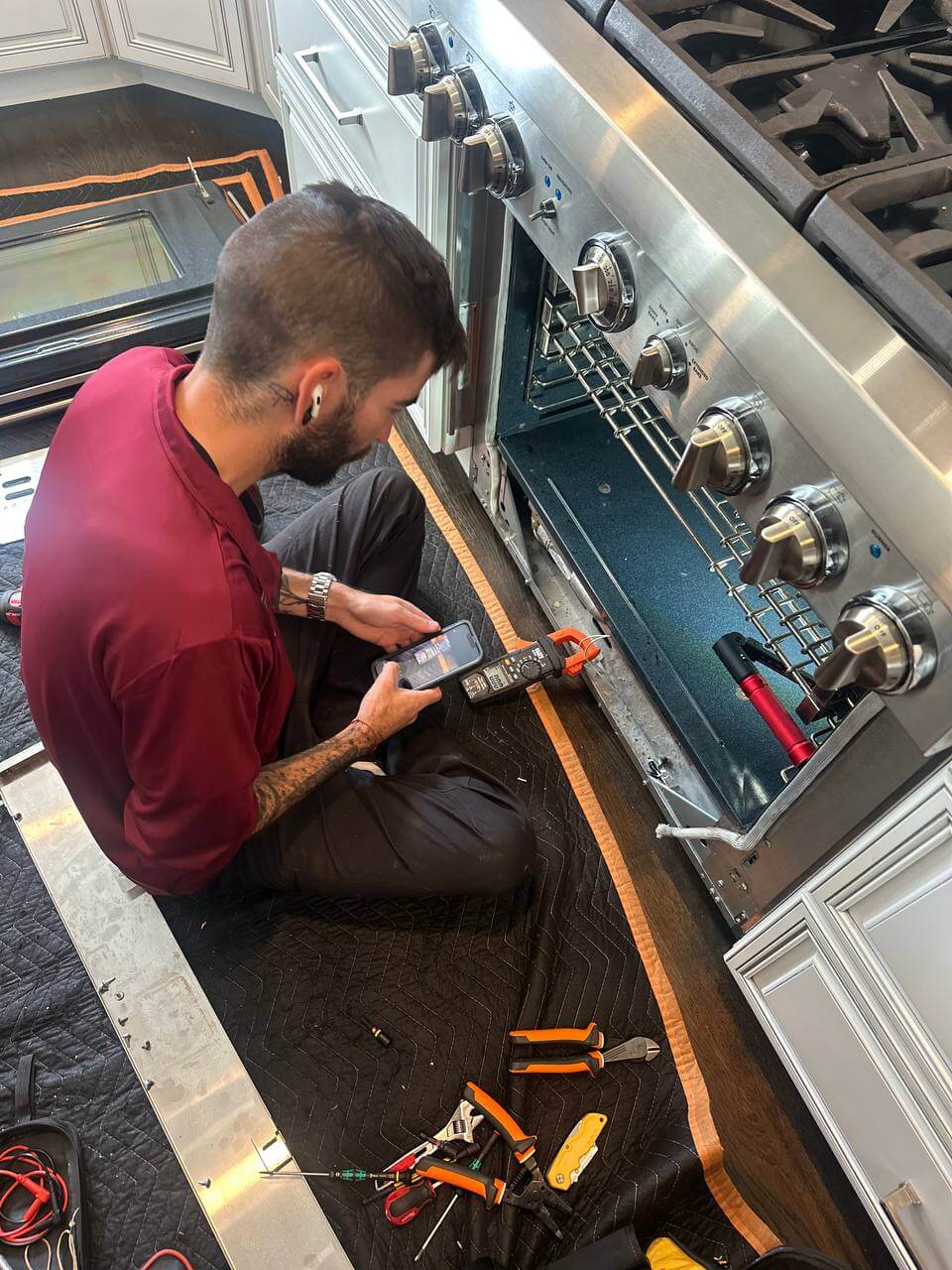 JIC worker repairing an oven