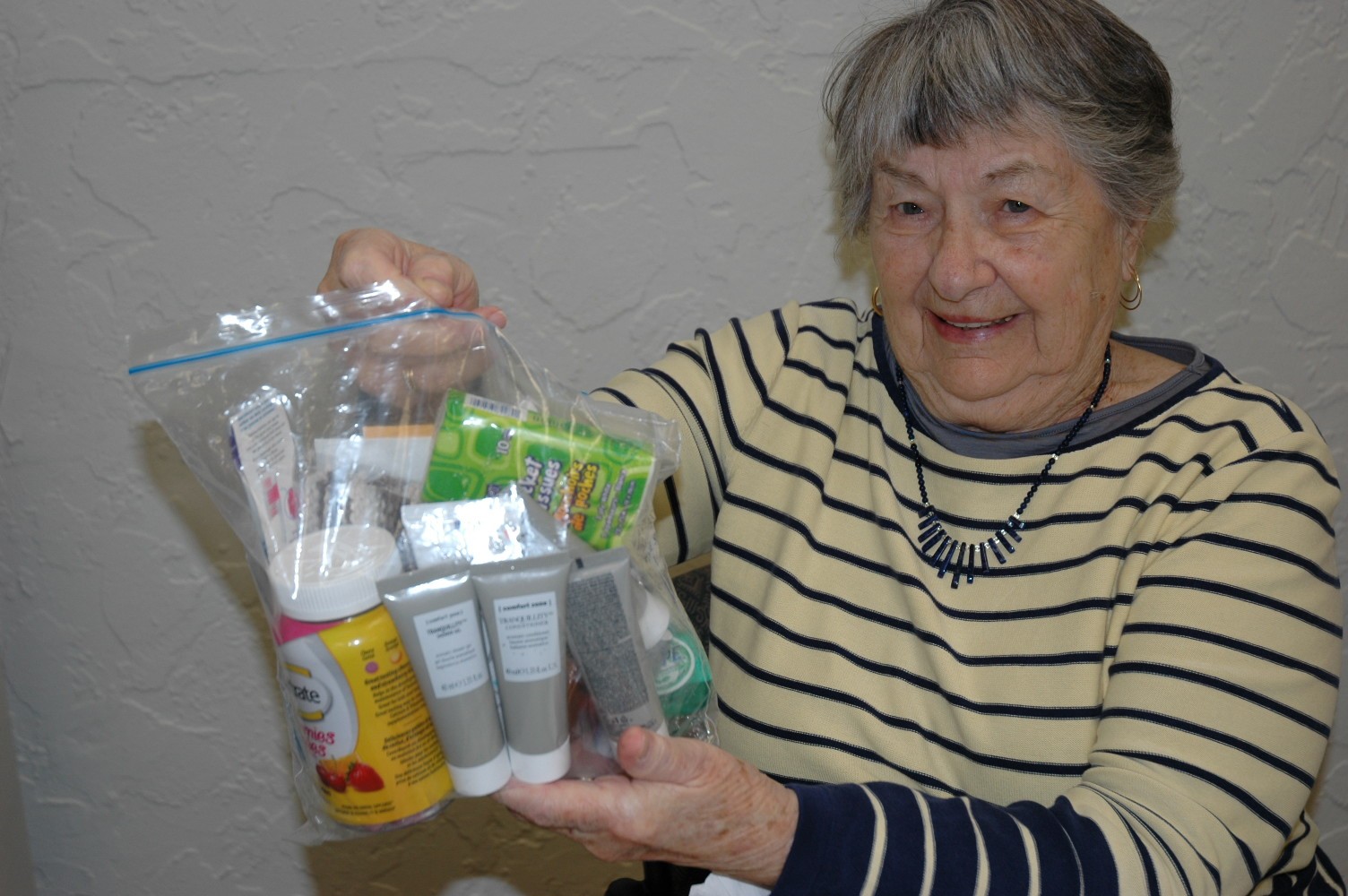 smilling senior with hygiene package