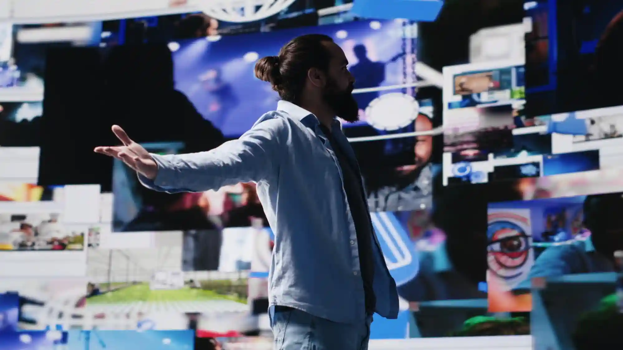 A creator stands before a digital wall of video content, illustrating the vast reach of modern social media marketing.