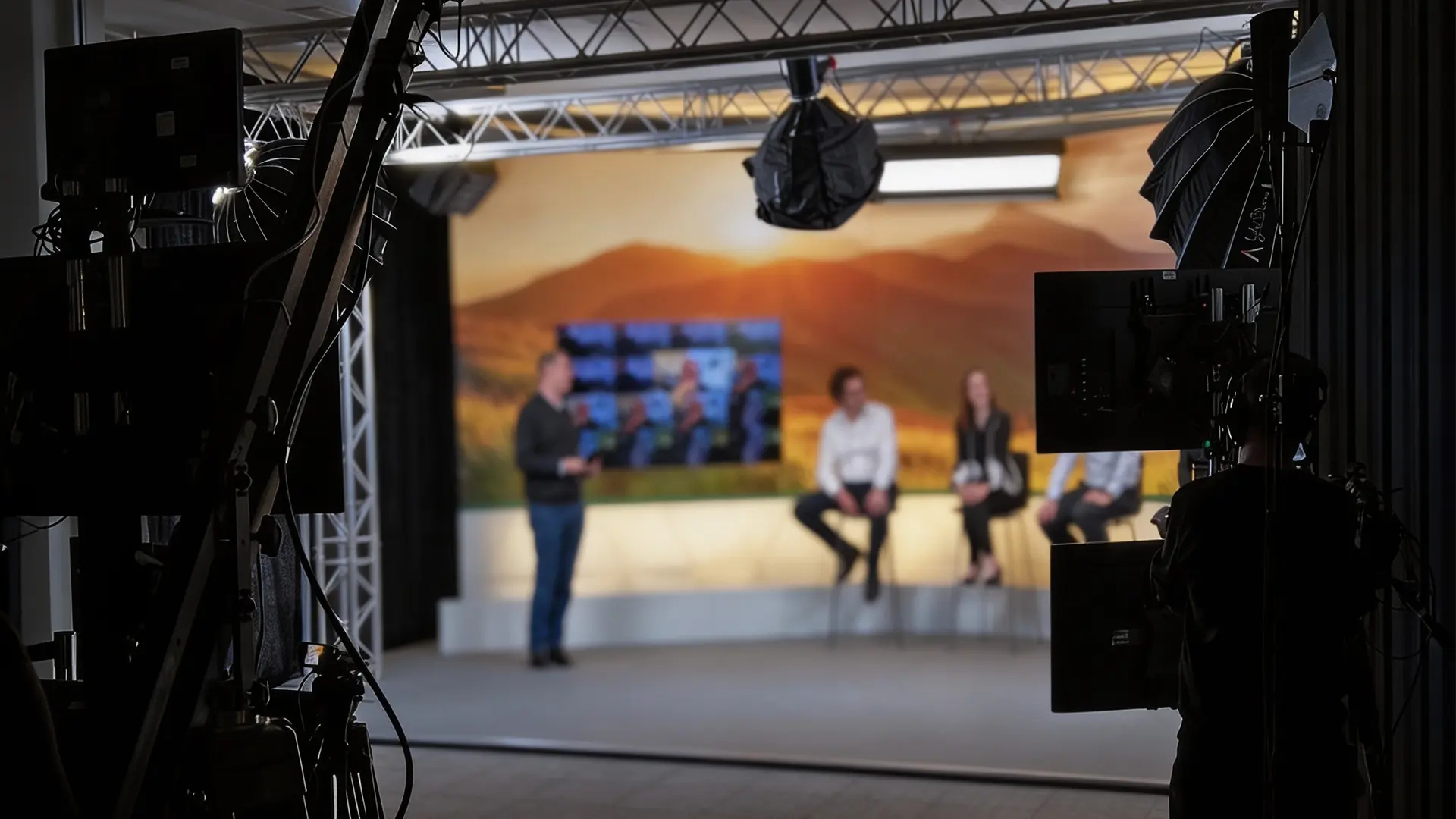 Professional filming setup capturing an interview in a controlled studio environment.