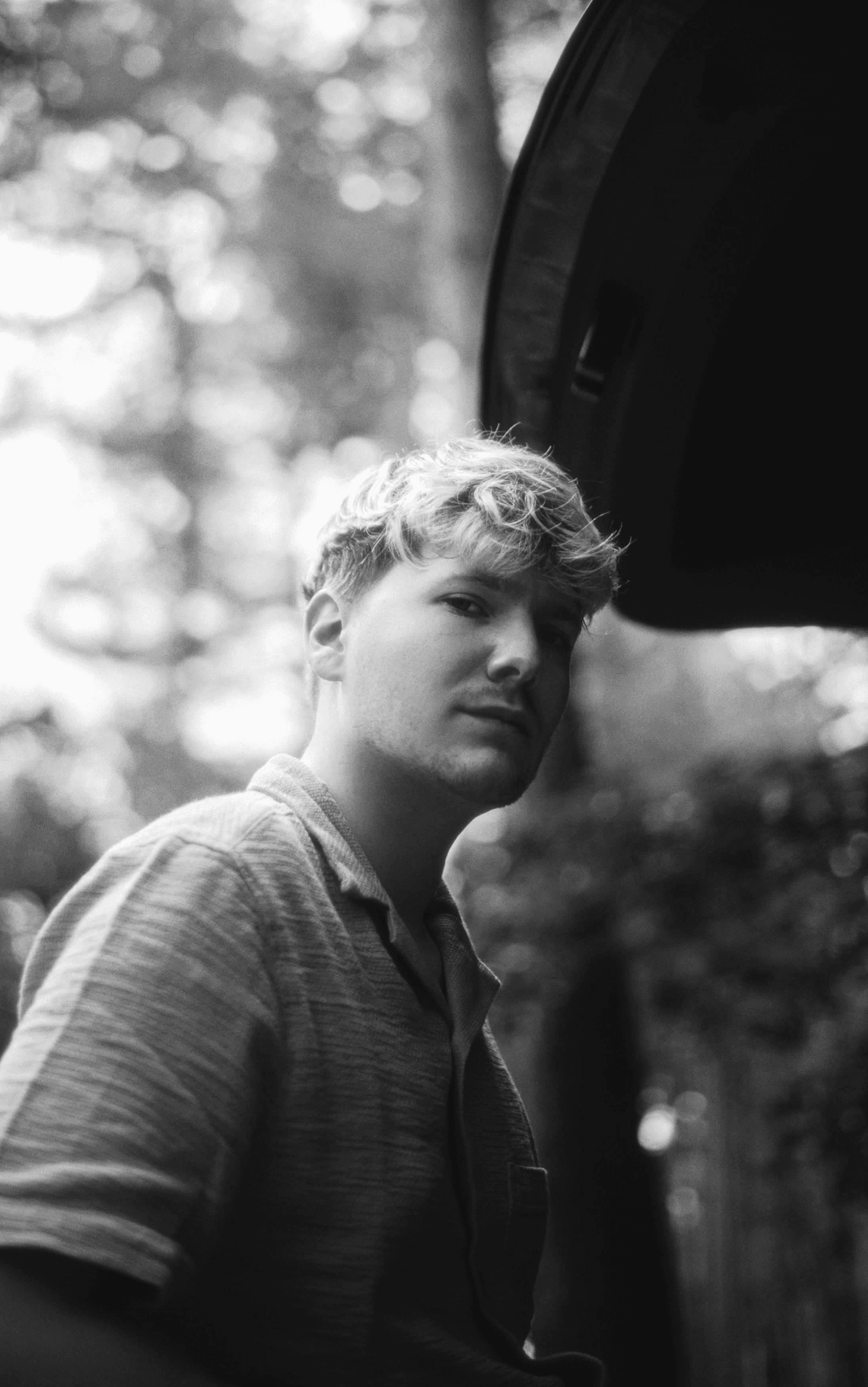 Black and white photo of man posing on camera