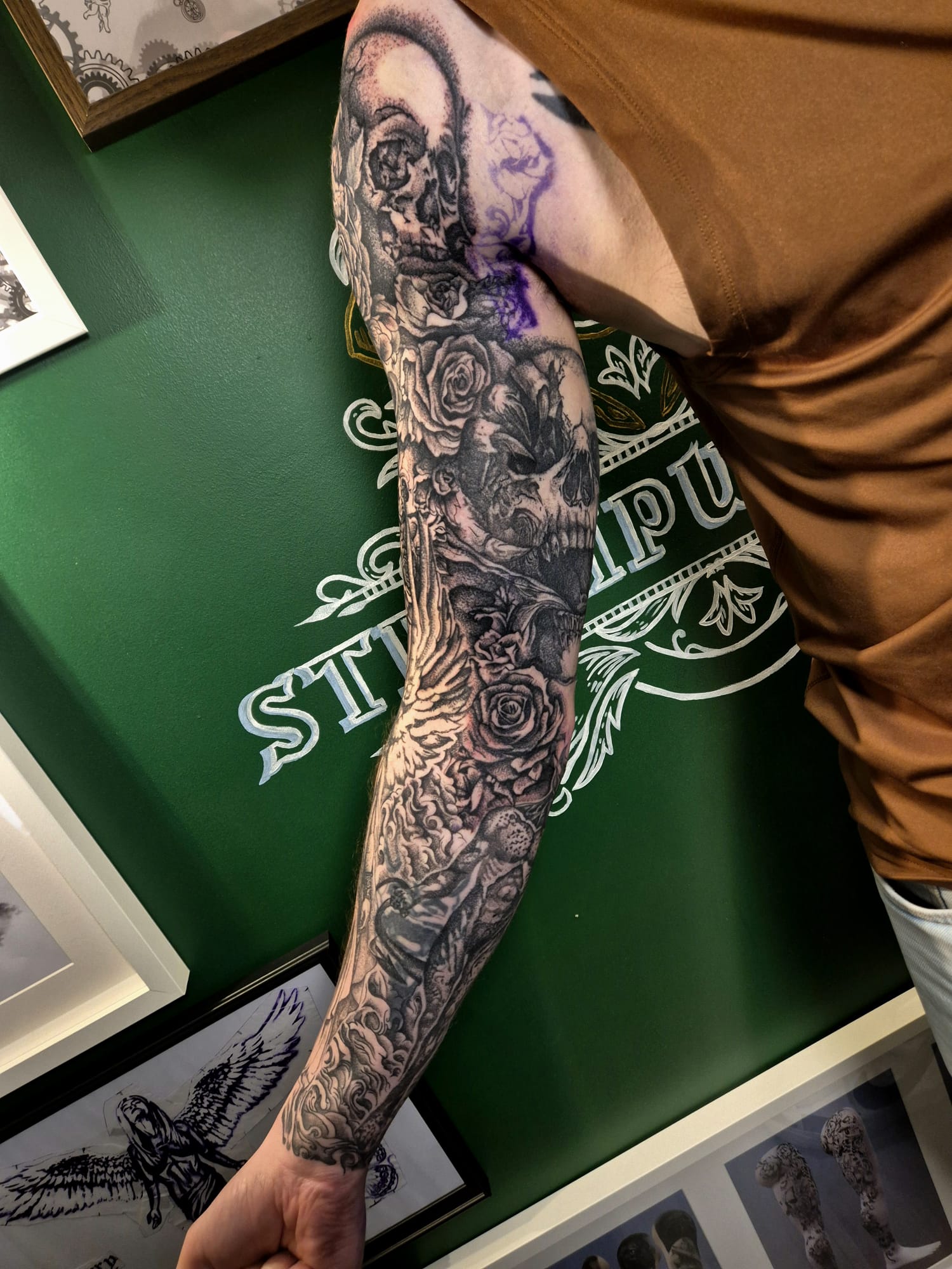 Skull and roses forearm tattoo in black and grey in Hazel Grove