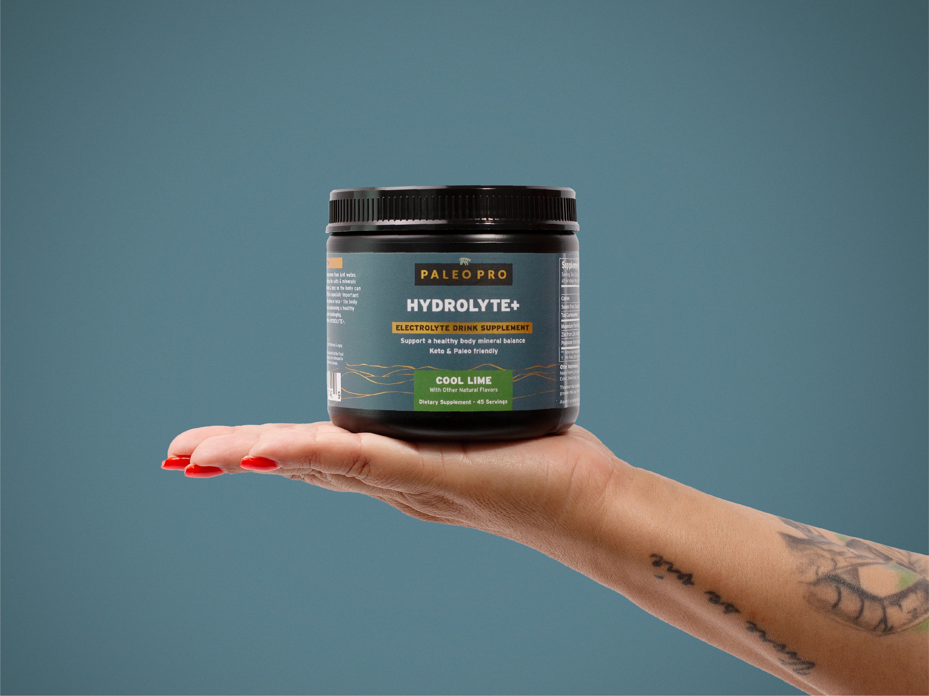 hand holding PaleoPro Hydrolyte hydration mix tub