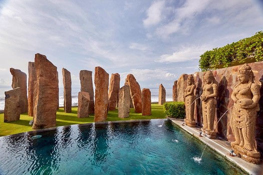 Stunning villa pool with stone statues in Gianyar. Your trusted agent for unique and artistic Bali residences.
