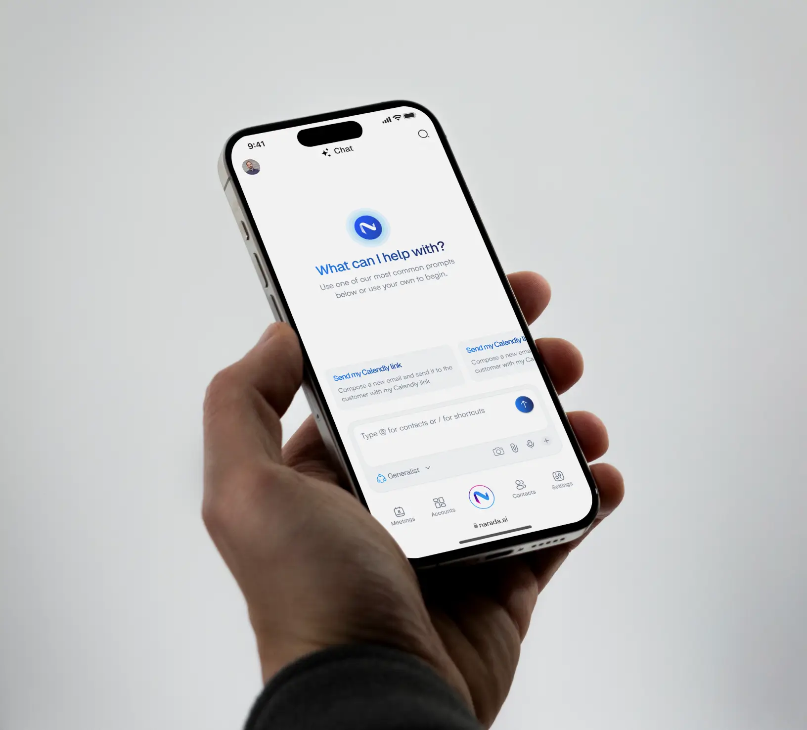 A hand holding a phone showing a website interface.