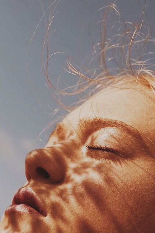 a woman holding a red flower