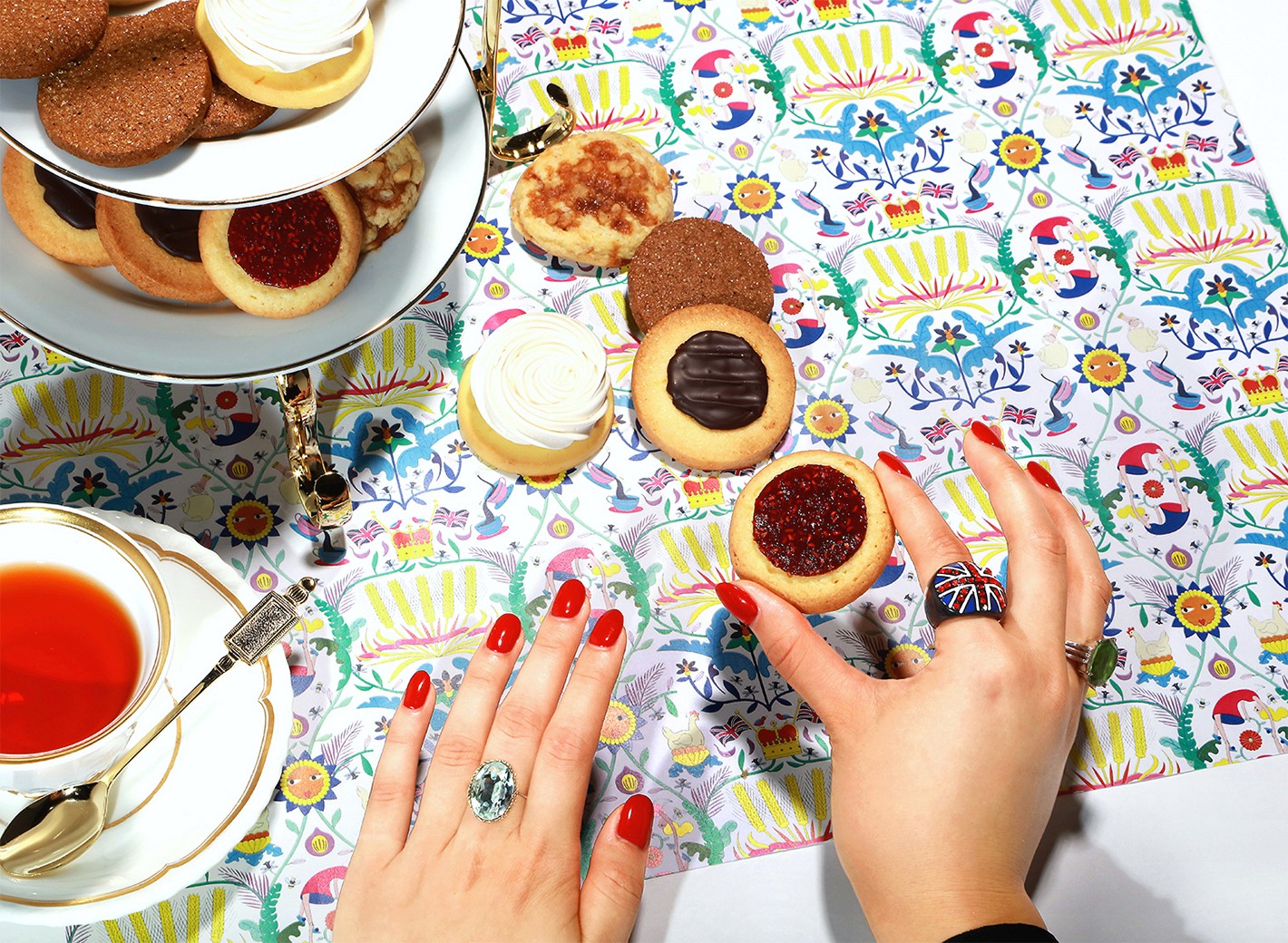Overhead view of cookies served on a table covered with a colorful illustrated Cookie Union pattern.