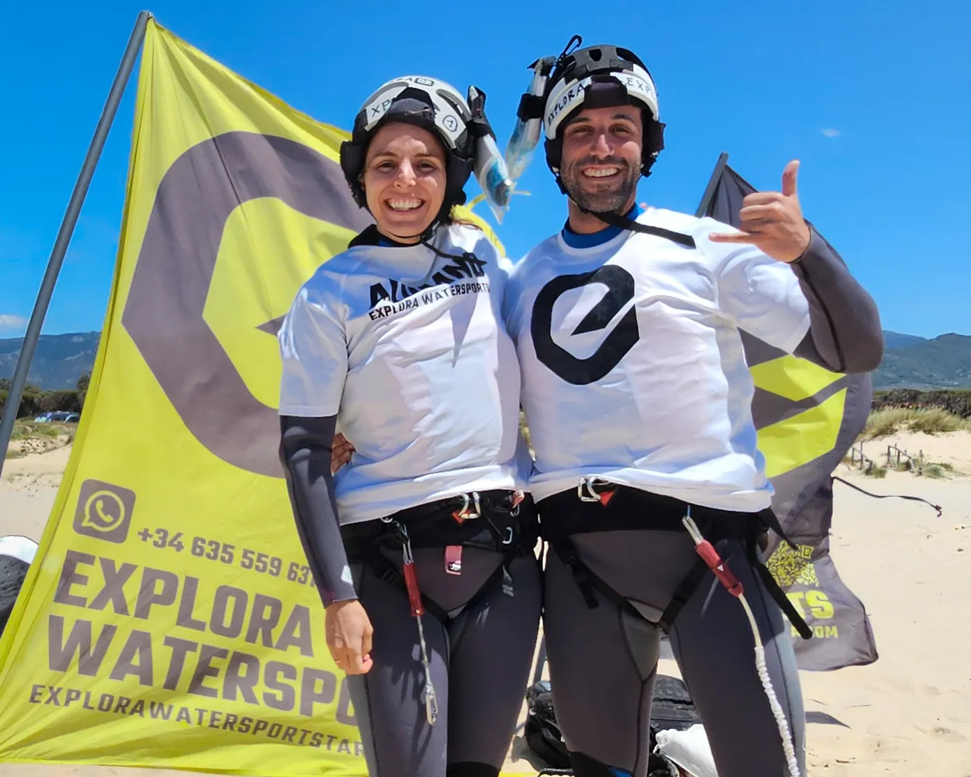 Happy beginner kitesurf students posing after their lesson at Los Lances beach — Explora Watersports Tarifa