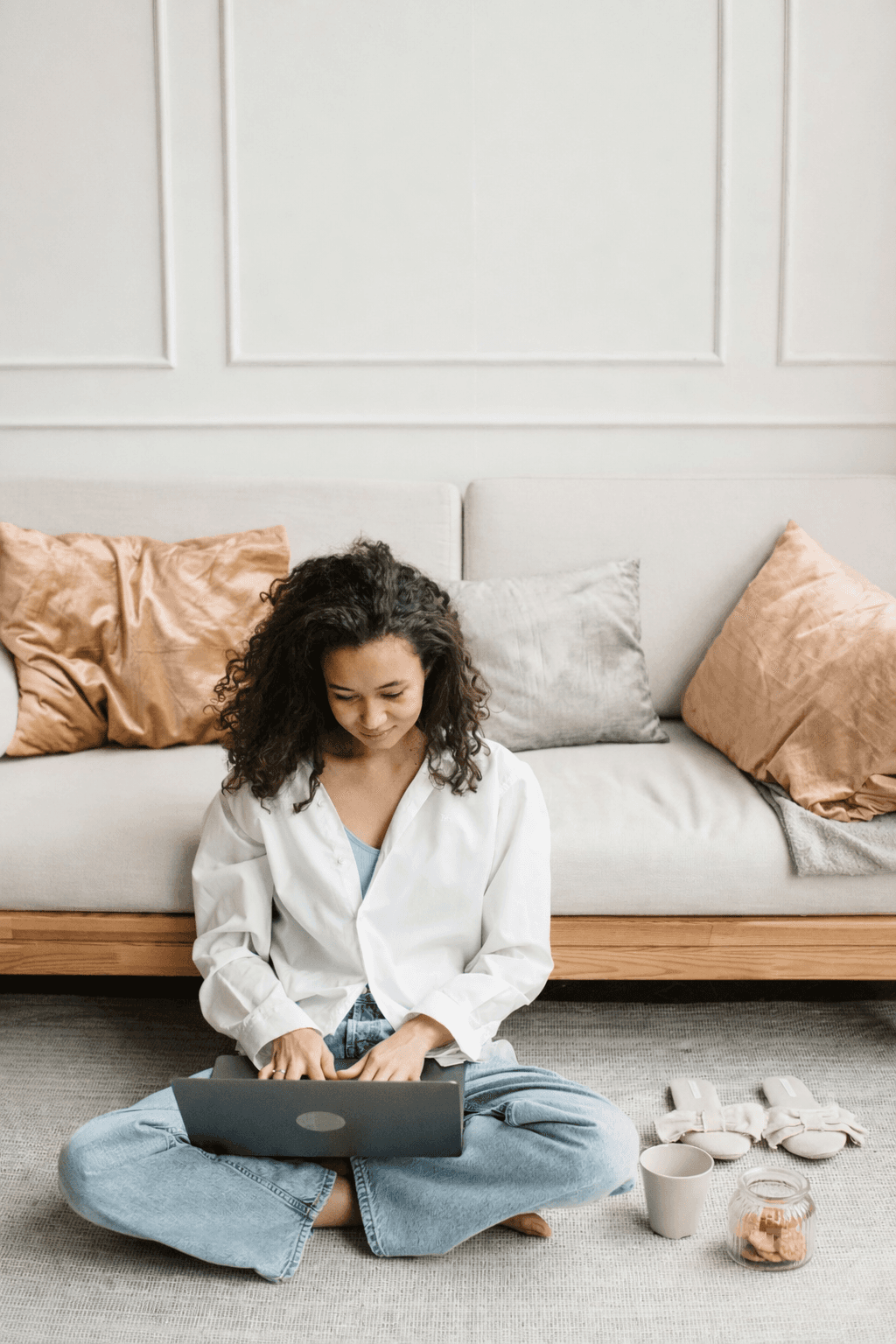 Smiling small business owner receives a package from a courier with a business phone system displayed, highlighting customer engagement and virtual receptionist.