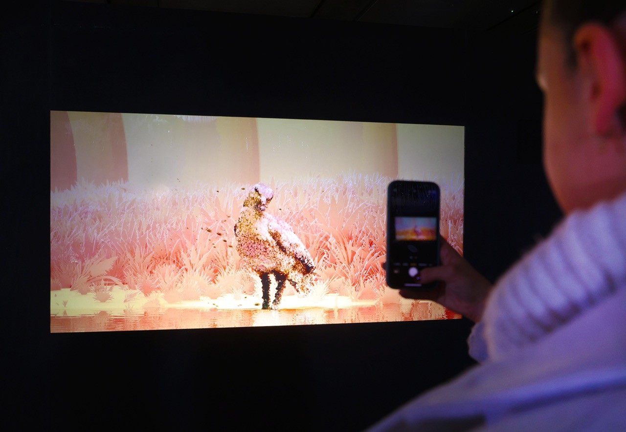 Woman wears a blue coat in a blue environment.