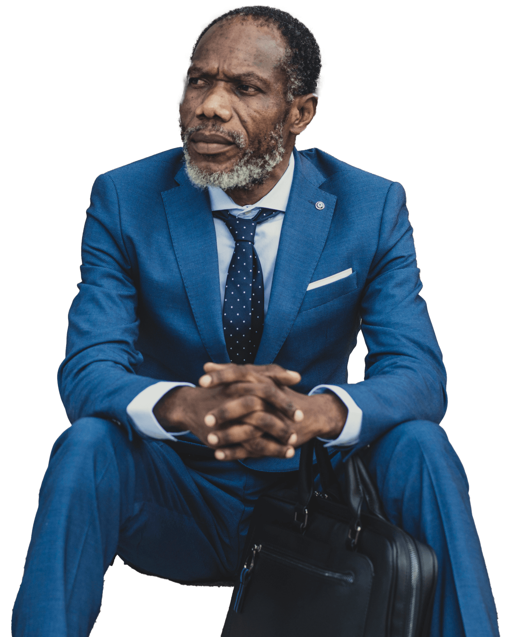 Image of Tarone sitting with hands folded looking distant