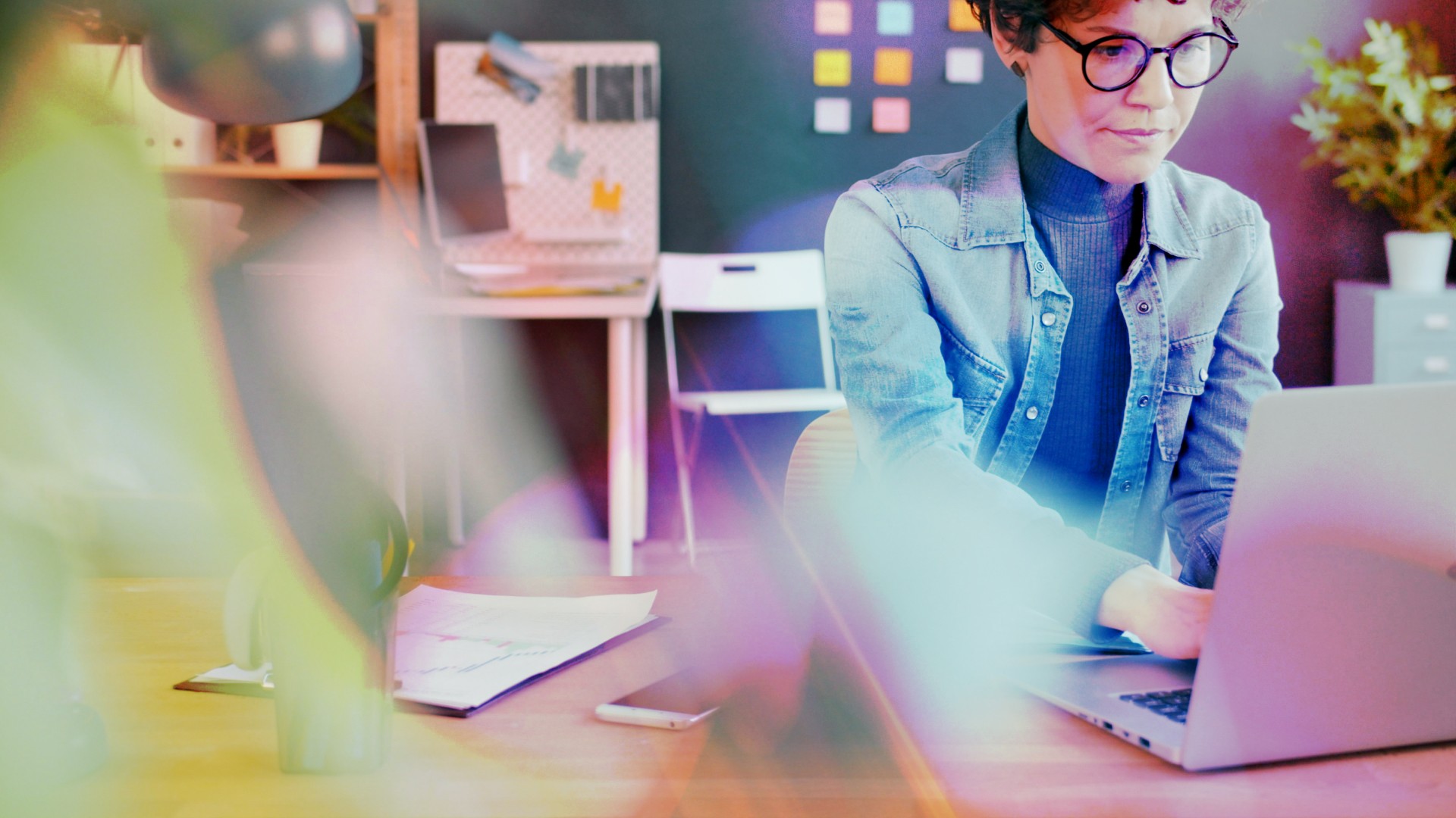A woman works at her laptop