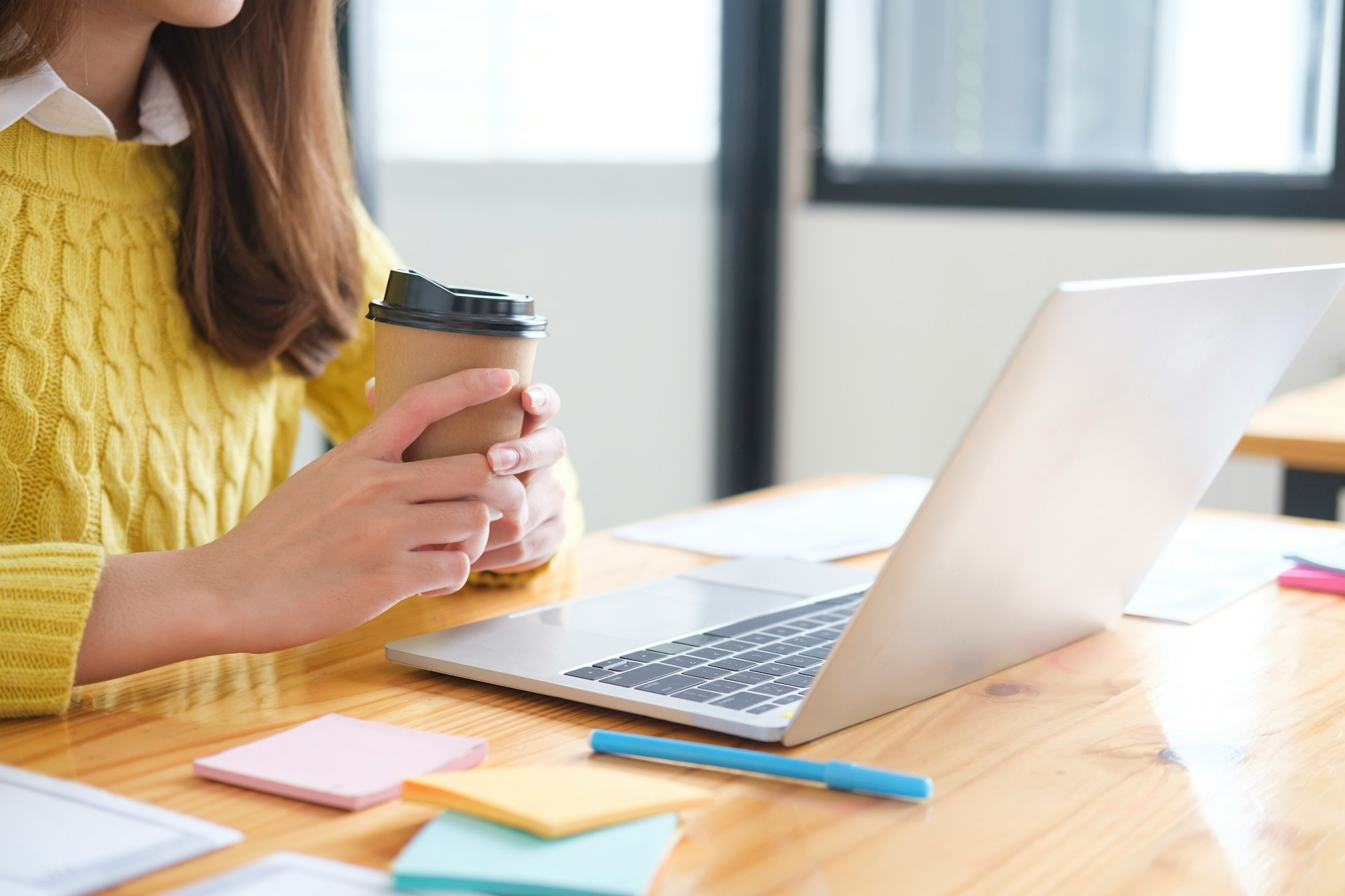 A woman holding a cup of coffee