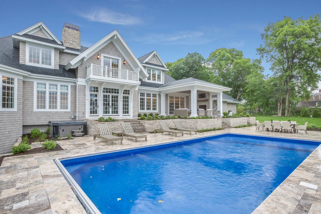 Large custom home with pool and patio.