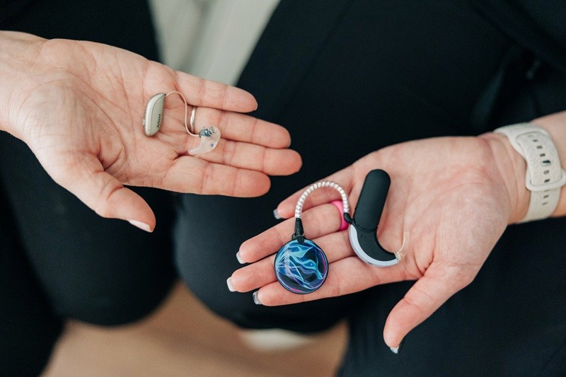 a woman is putting a pair of earplugs on her ear