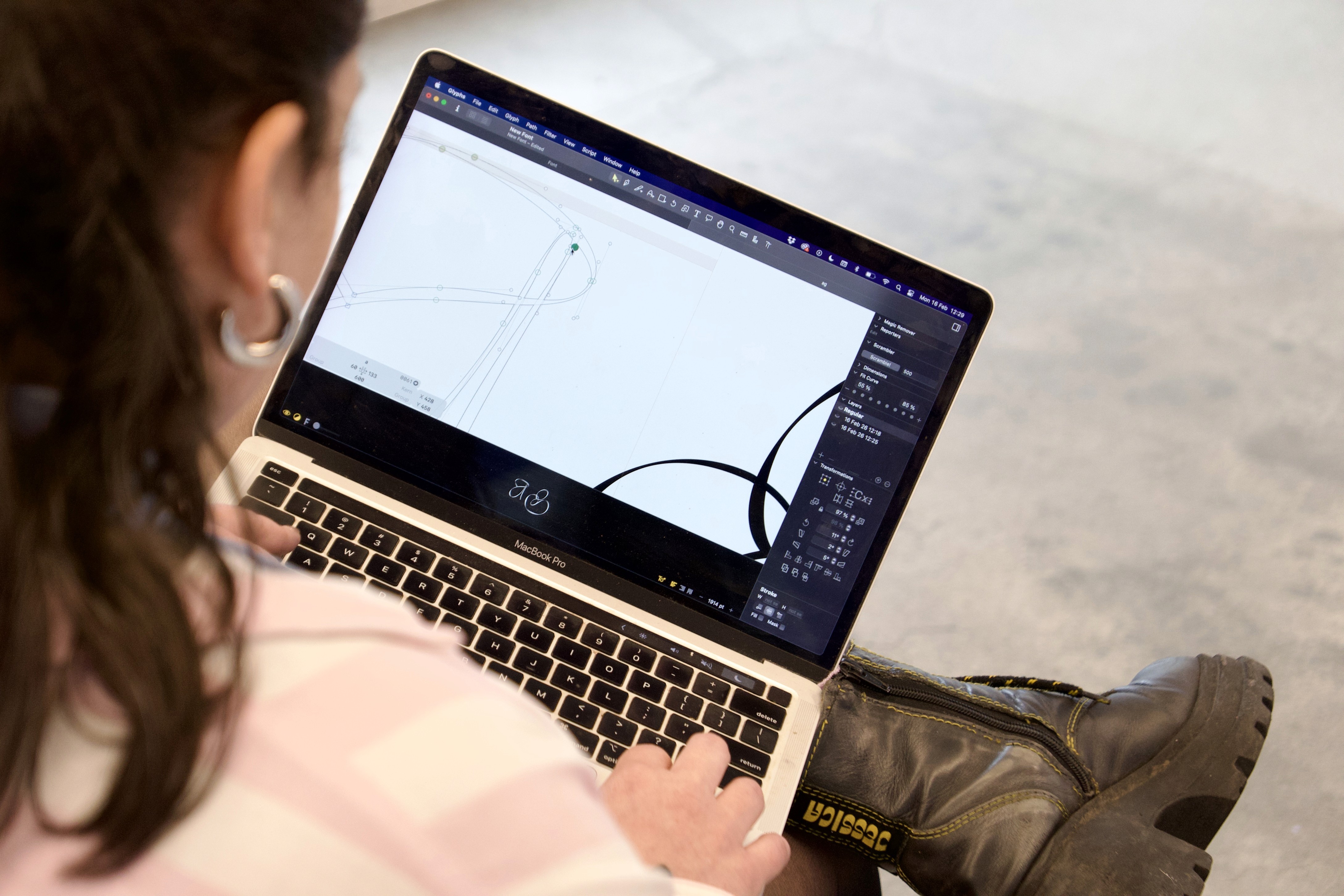 type designer designing letters on laptop