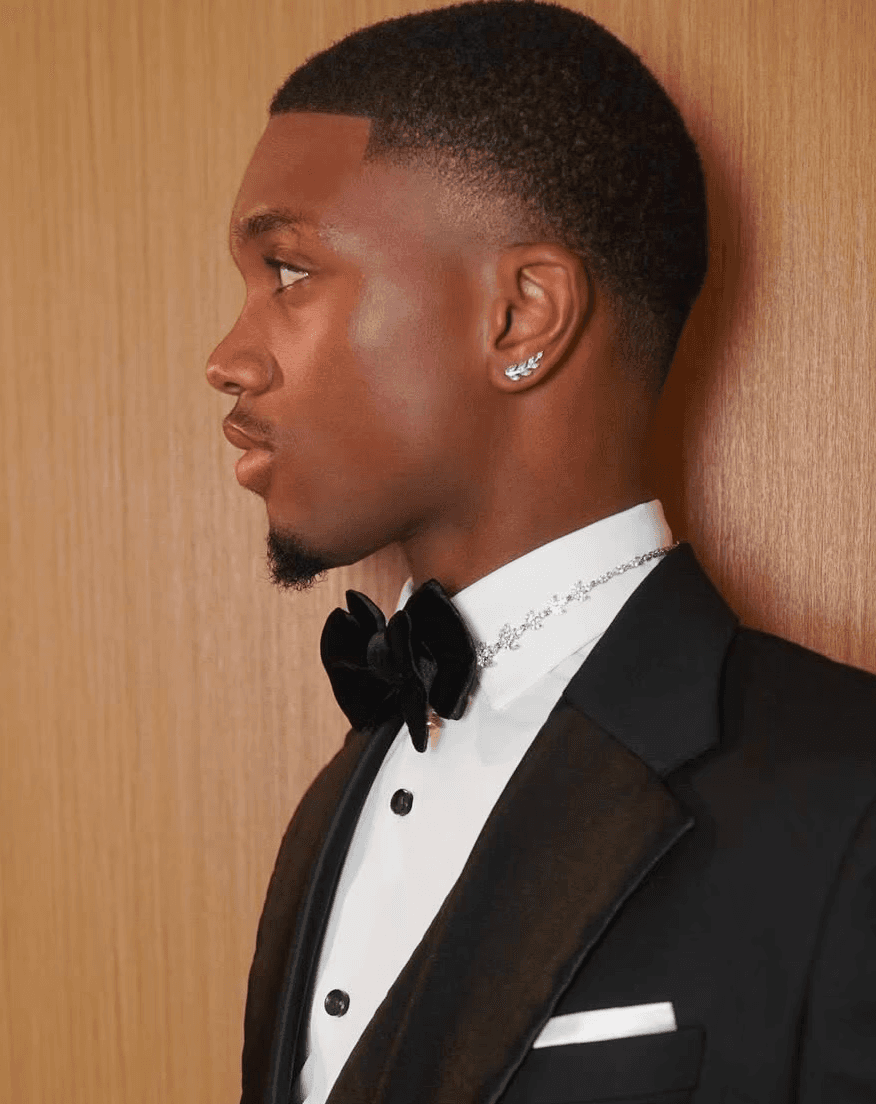 Classic high taper fade for men, highlighting a natural hairline and youthful styling by Courtney Palmore.