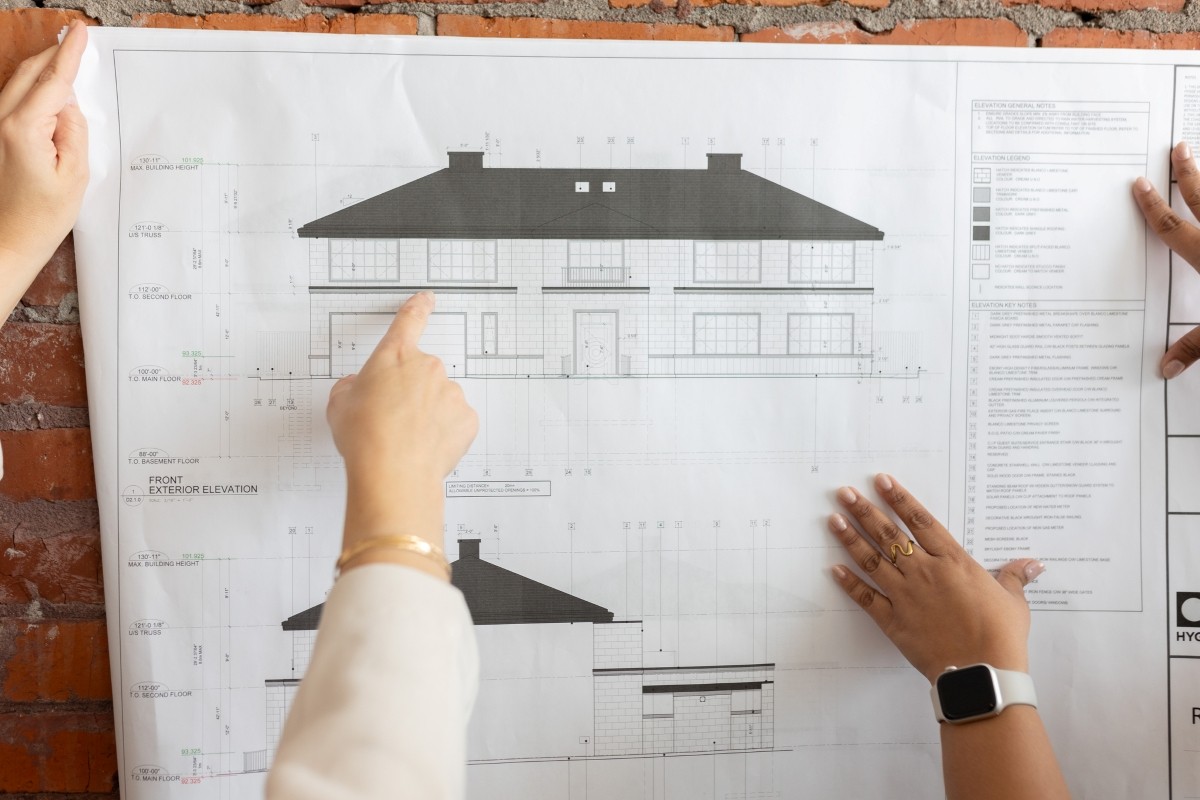 Calgary interior designer Springbank Hill Kitchen with two-toned custom cabinets in warm white and a light, warm wood, light countertops, dark island lights, and dark faucet.
