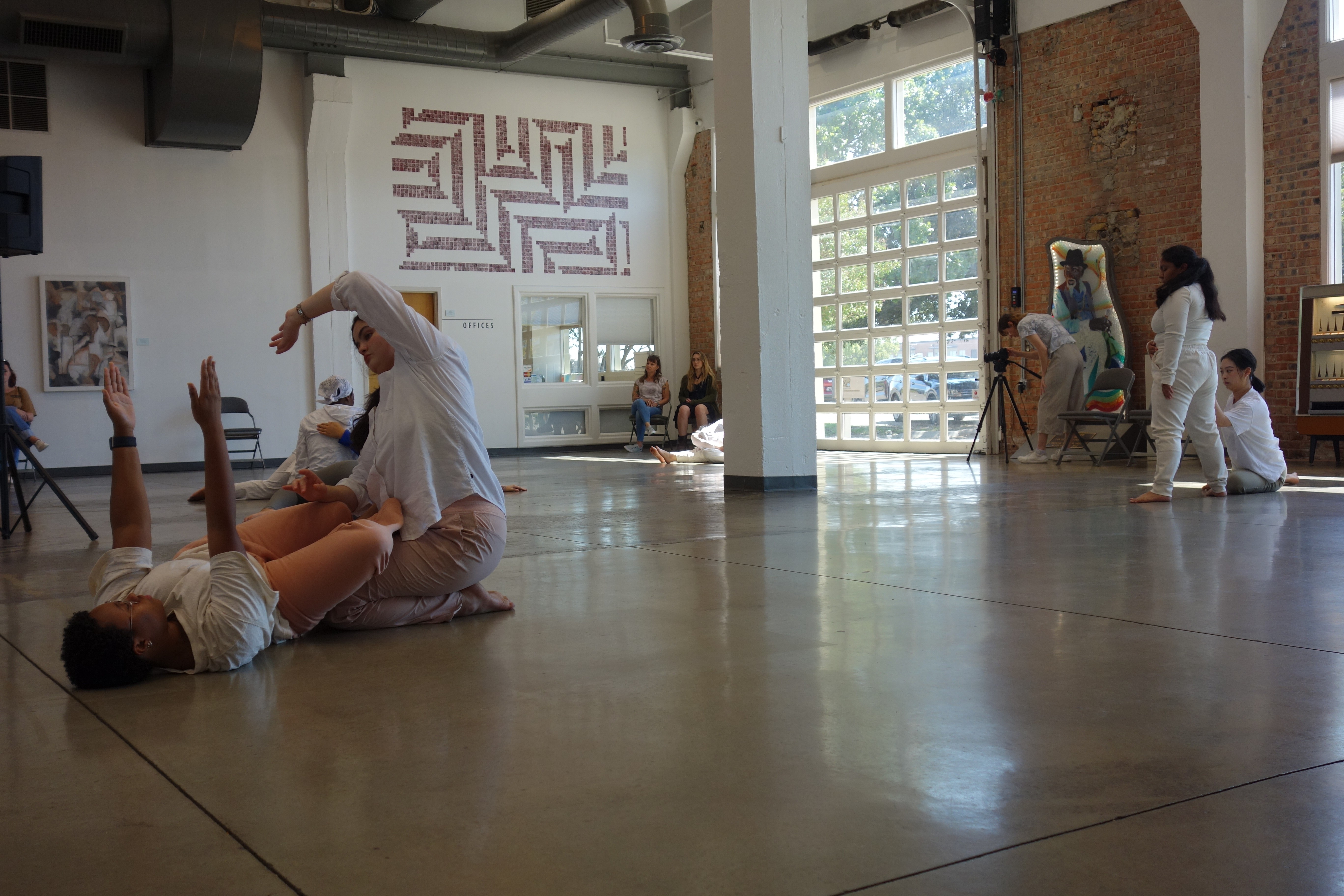 person sitting on grass and using phone