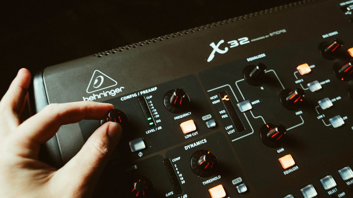 Cover image for MxU's free worship ministry resource, titled 'X32 Showfile', shows a hand adjusting a knob on a Behringer X32 mixing console.