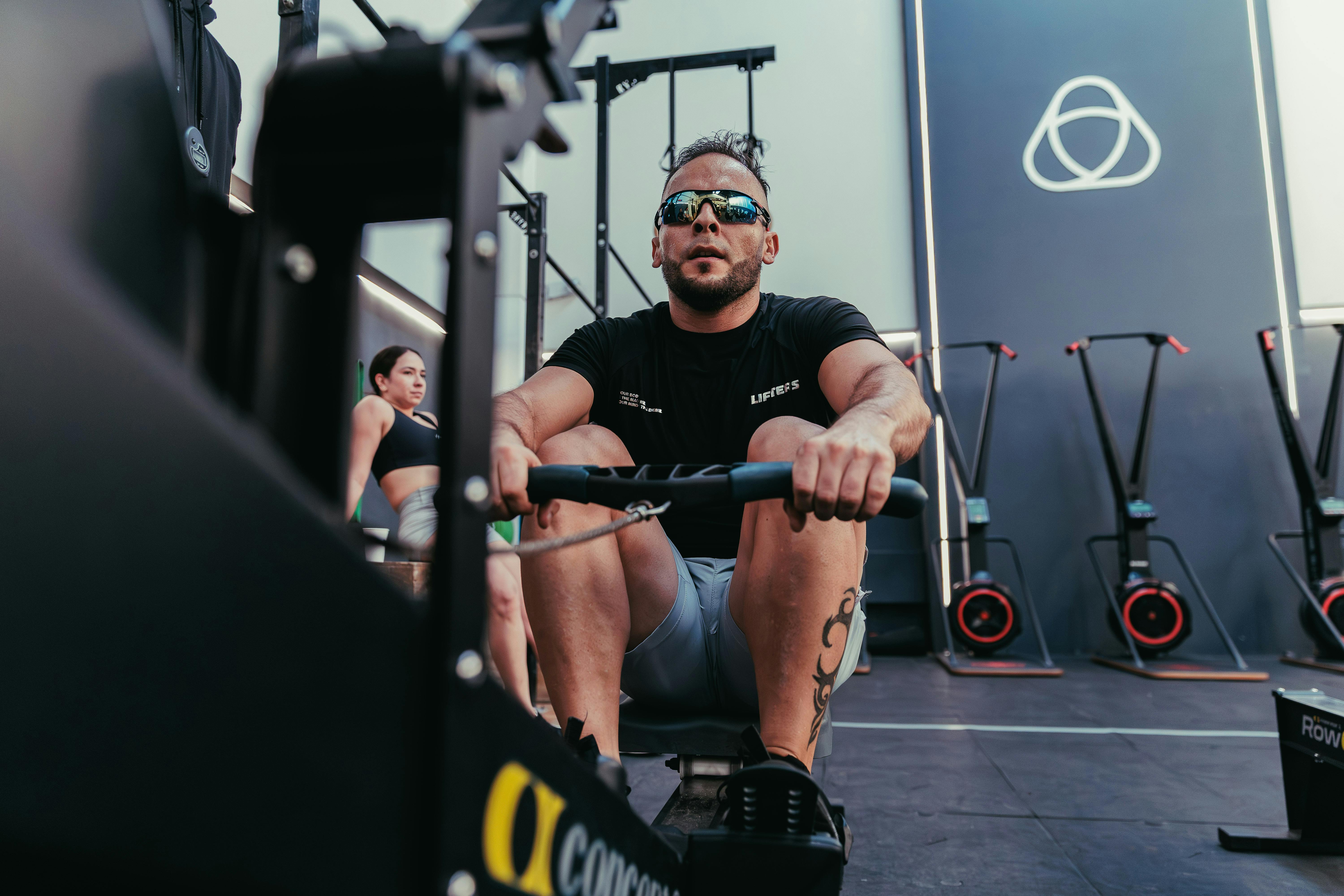 man in black shorts and black tank top doing push up