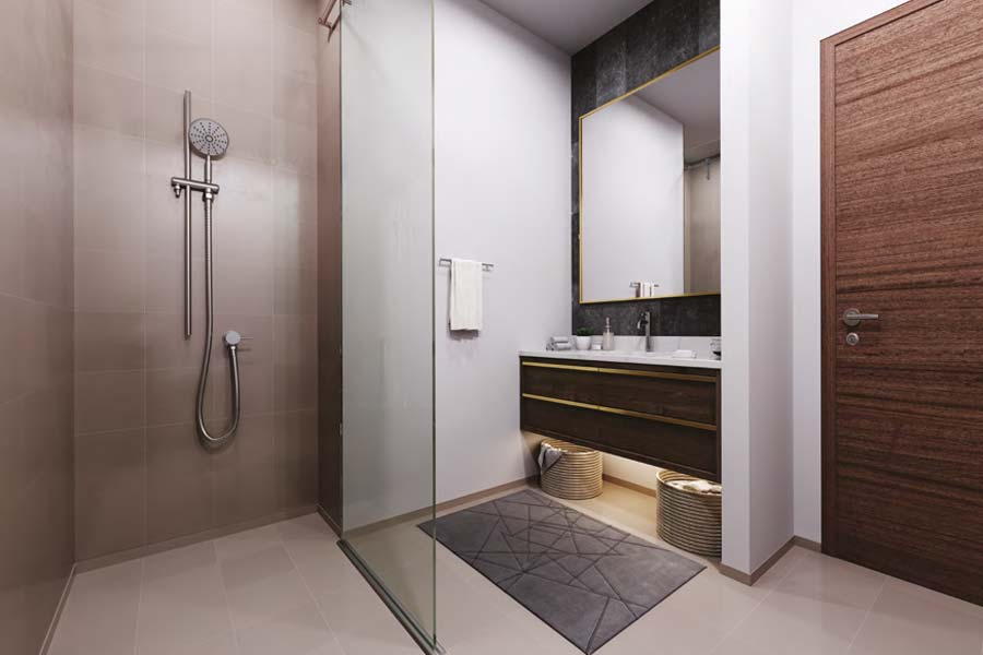 Interior view of a bathroom at Azizi Mirage, showcasing a shower, sink, and toilet in a contemporary layout