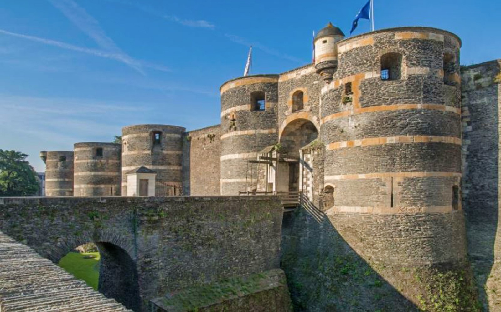 Angers Castle stone towers and entrance bridge in France.