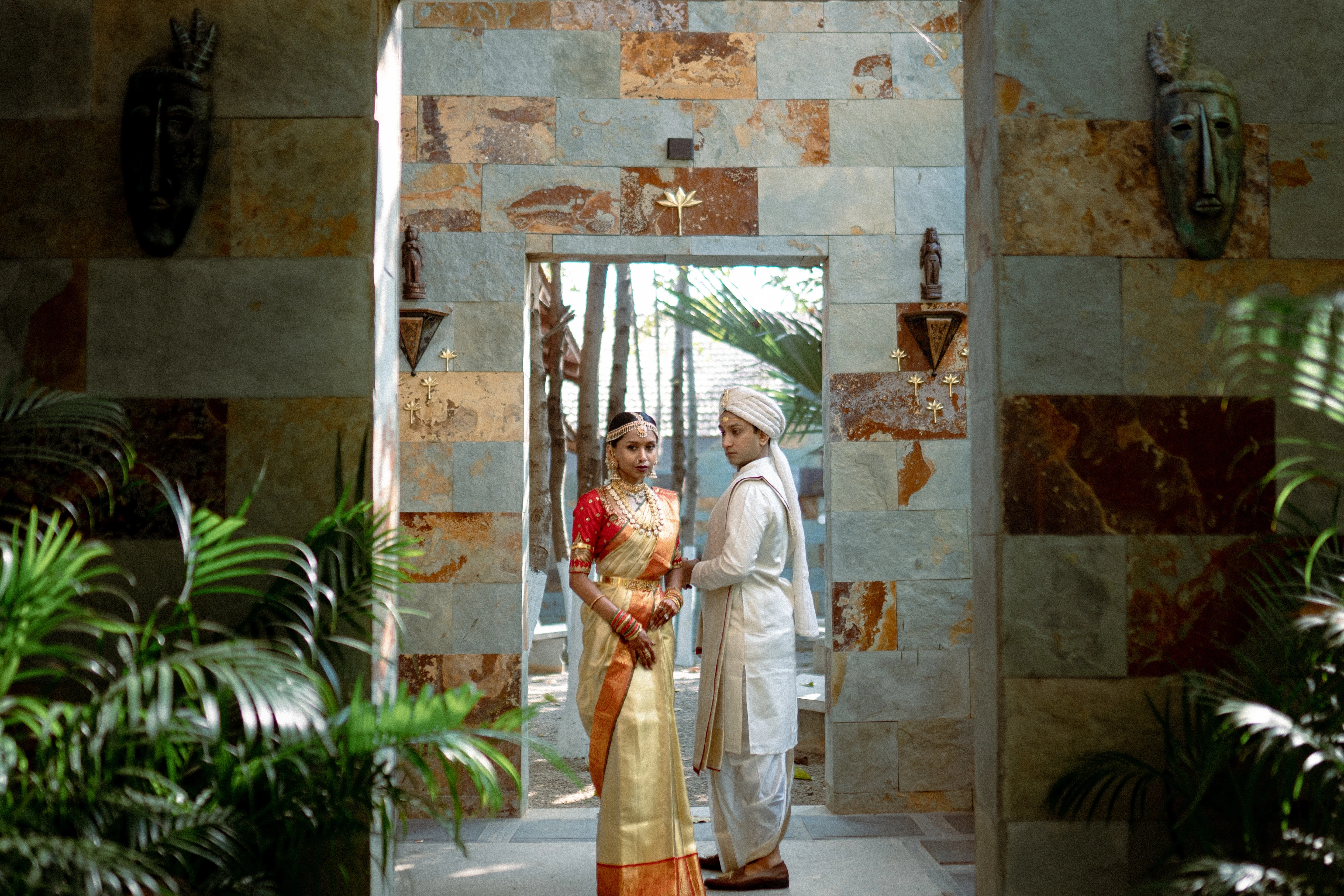 Couple in vibrant traditional Indian attire, showcasing rich colours and intricate designs. Photo by Out of The Blues Fine Art Wedding Photography in Hyderabad.