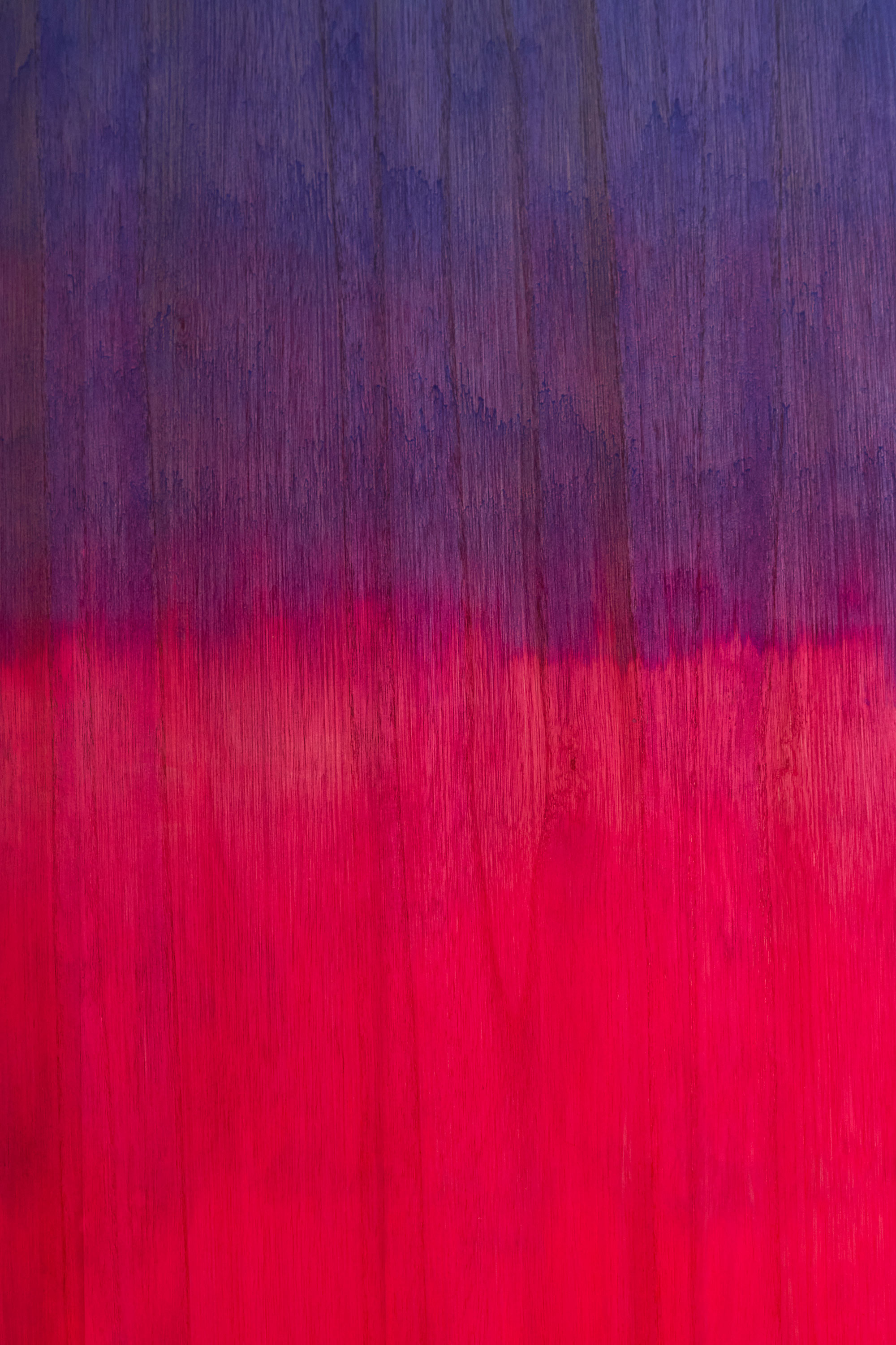 Purple and pink wood stain surfboard